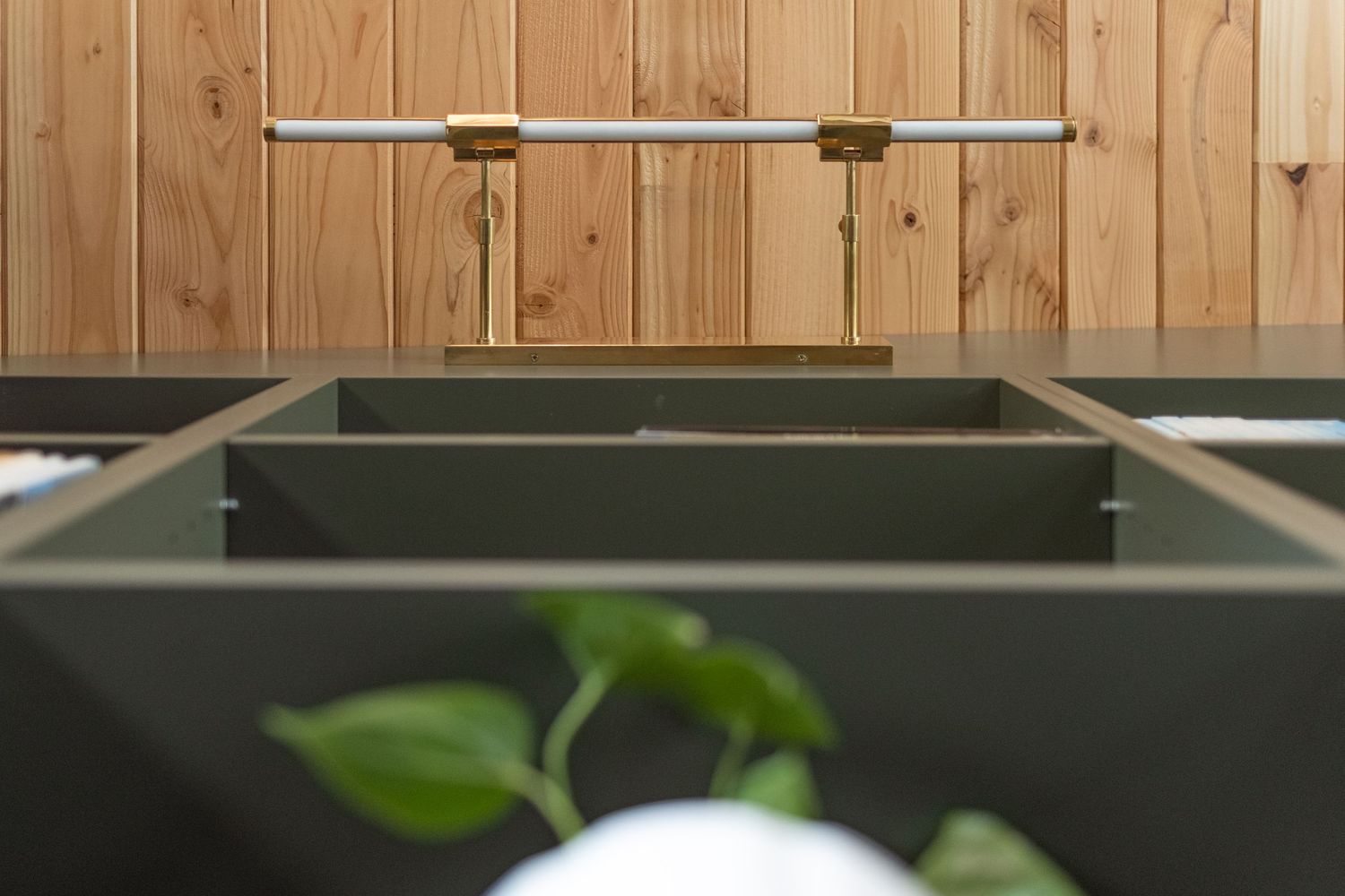 Wooden ceiling detail with modern track lighting in a contemporary interior space.
