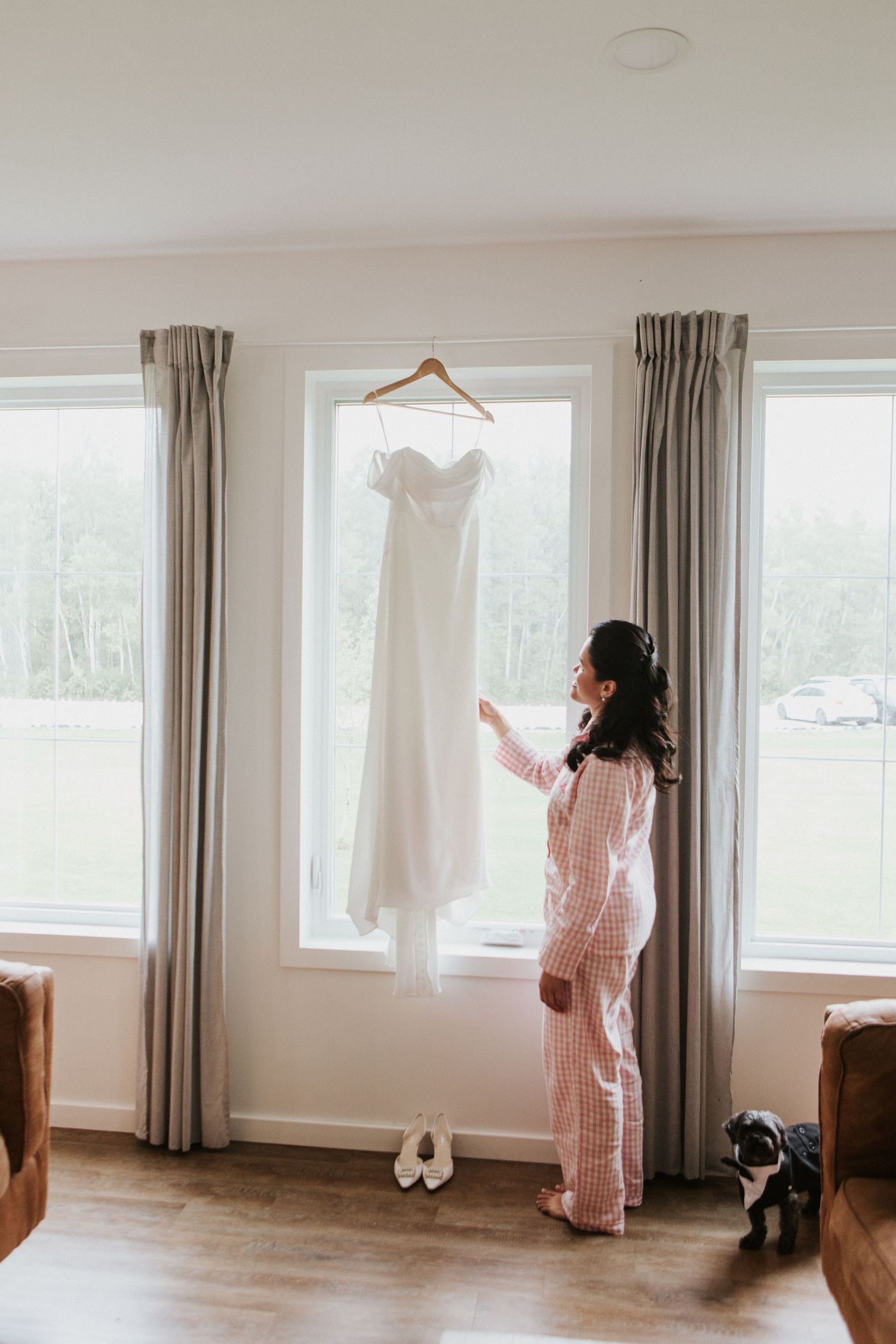 A series of photos showing a person in striped pajamas looking out large windows in a bright, minimalist room.