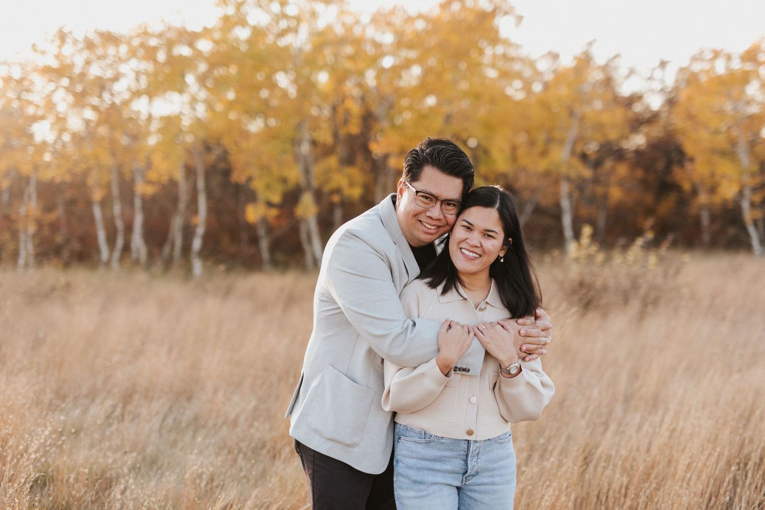 A romantic autumn photoshoot with golden leaves in the background.