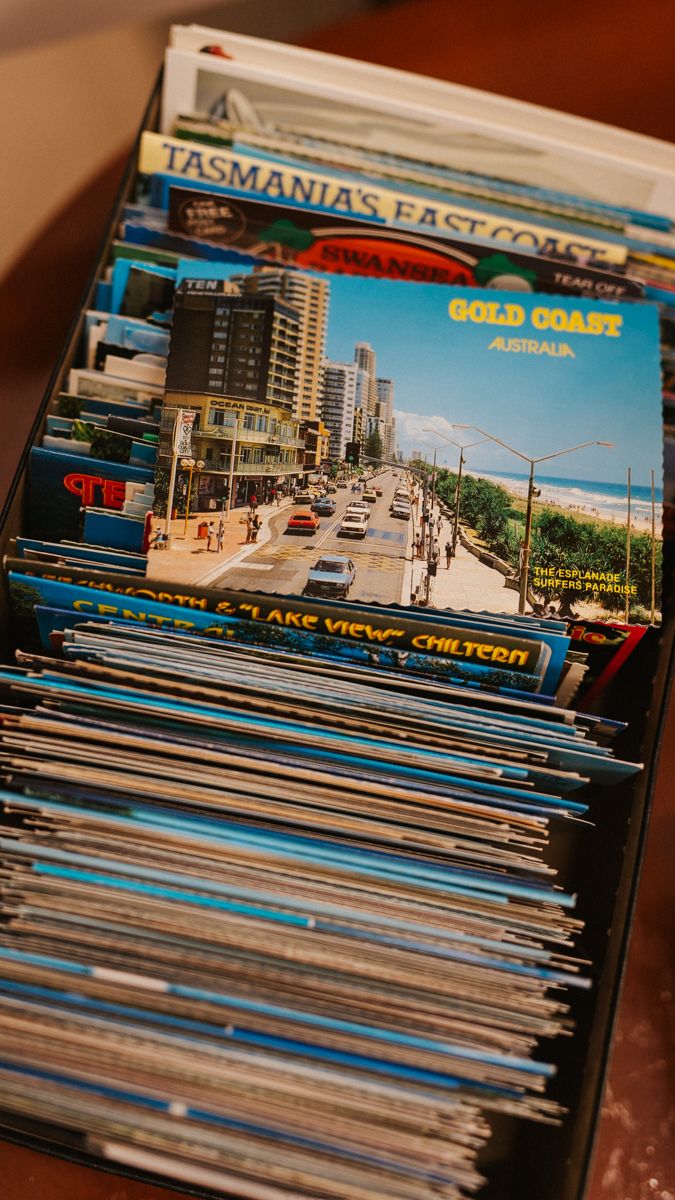 Stack of vintage postcards showing Australian coastal scenes and landmarks.
