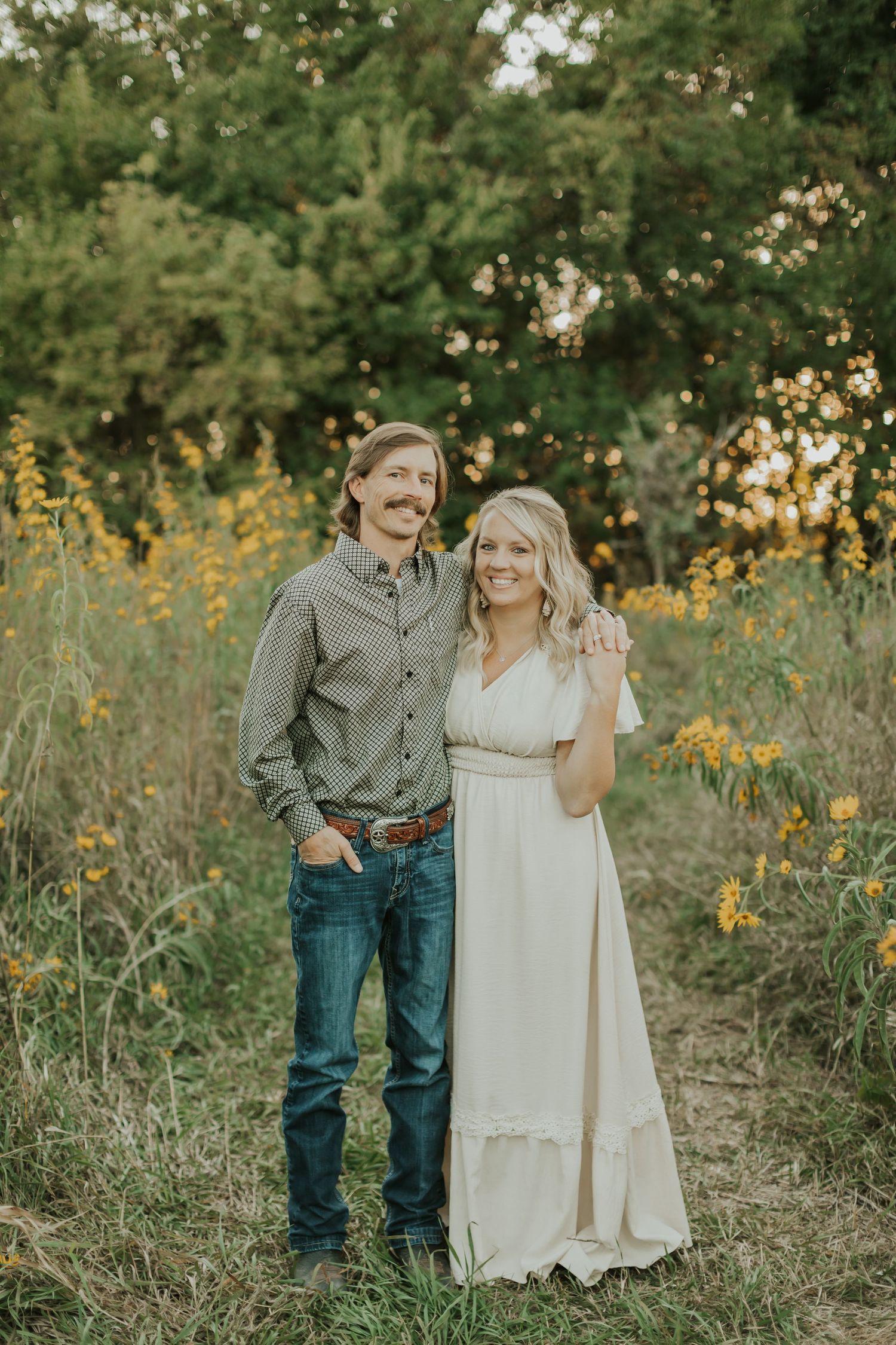 husband and wife portrait in wild flowers in iowa
