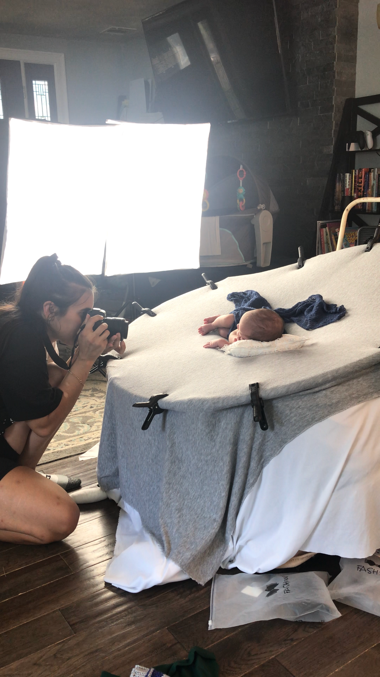 A photography session setup shows camera equipment and lighting for newborn portraits.