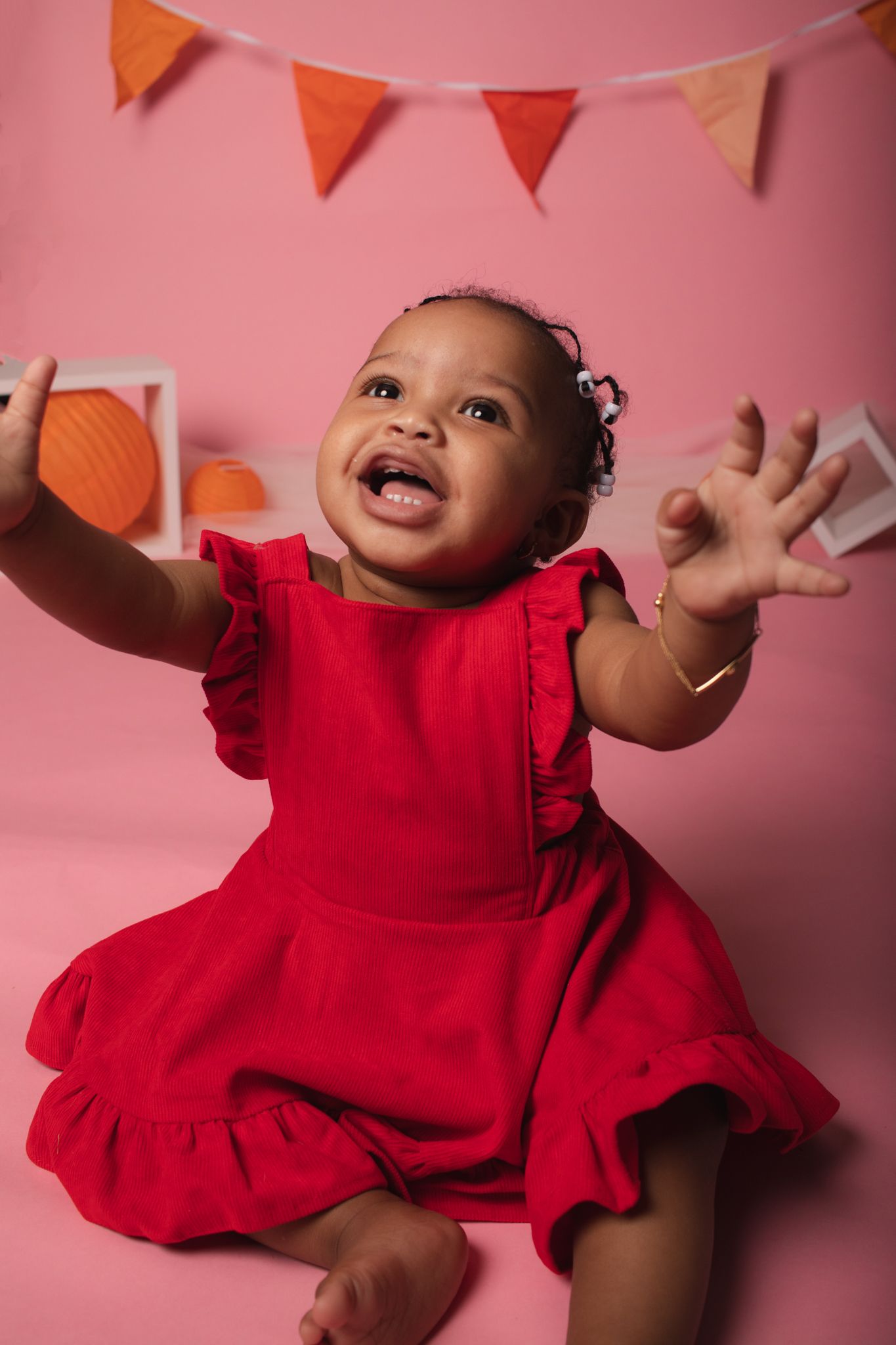 Joyful portrait against pink background with orange and red party bunting.
