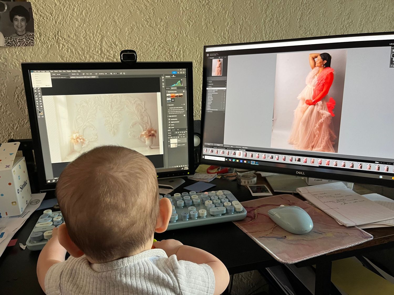 Child sitting at computer desk with dual monitor setup displaying photo editing software.
