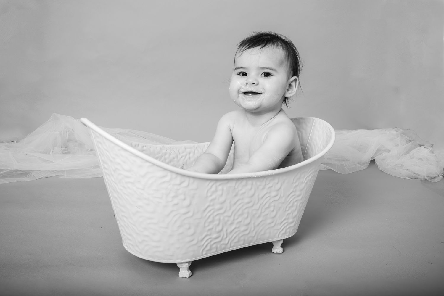 Classic black and white portrait in miniature bathtub setting.