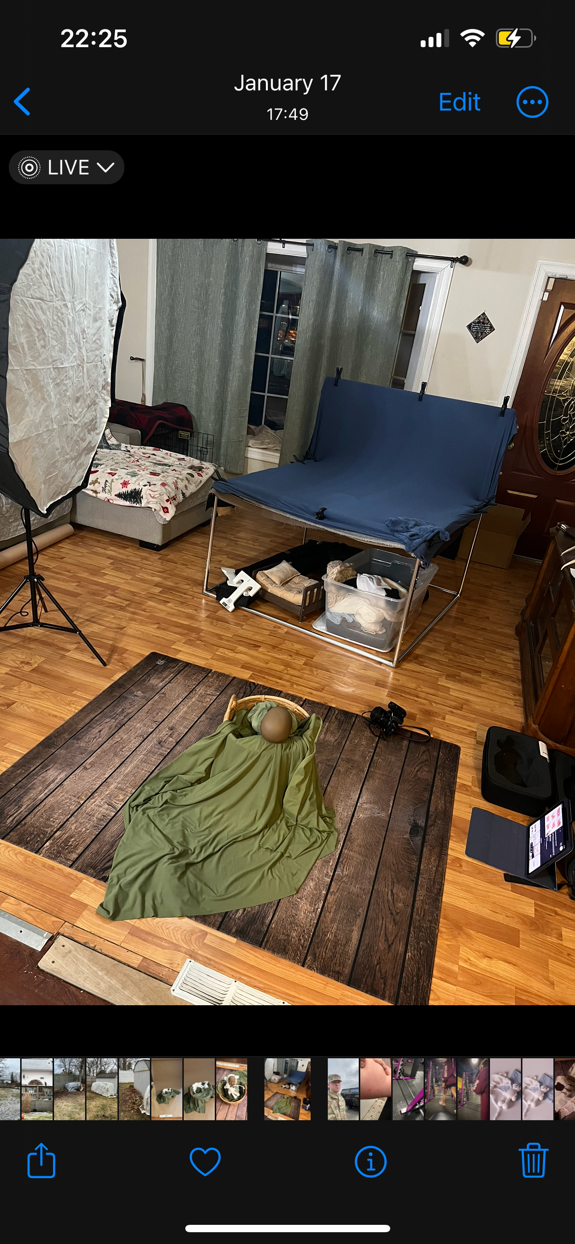 Professional photography setup with lighting equipment and blue backdrop in a home studio.