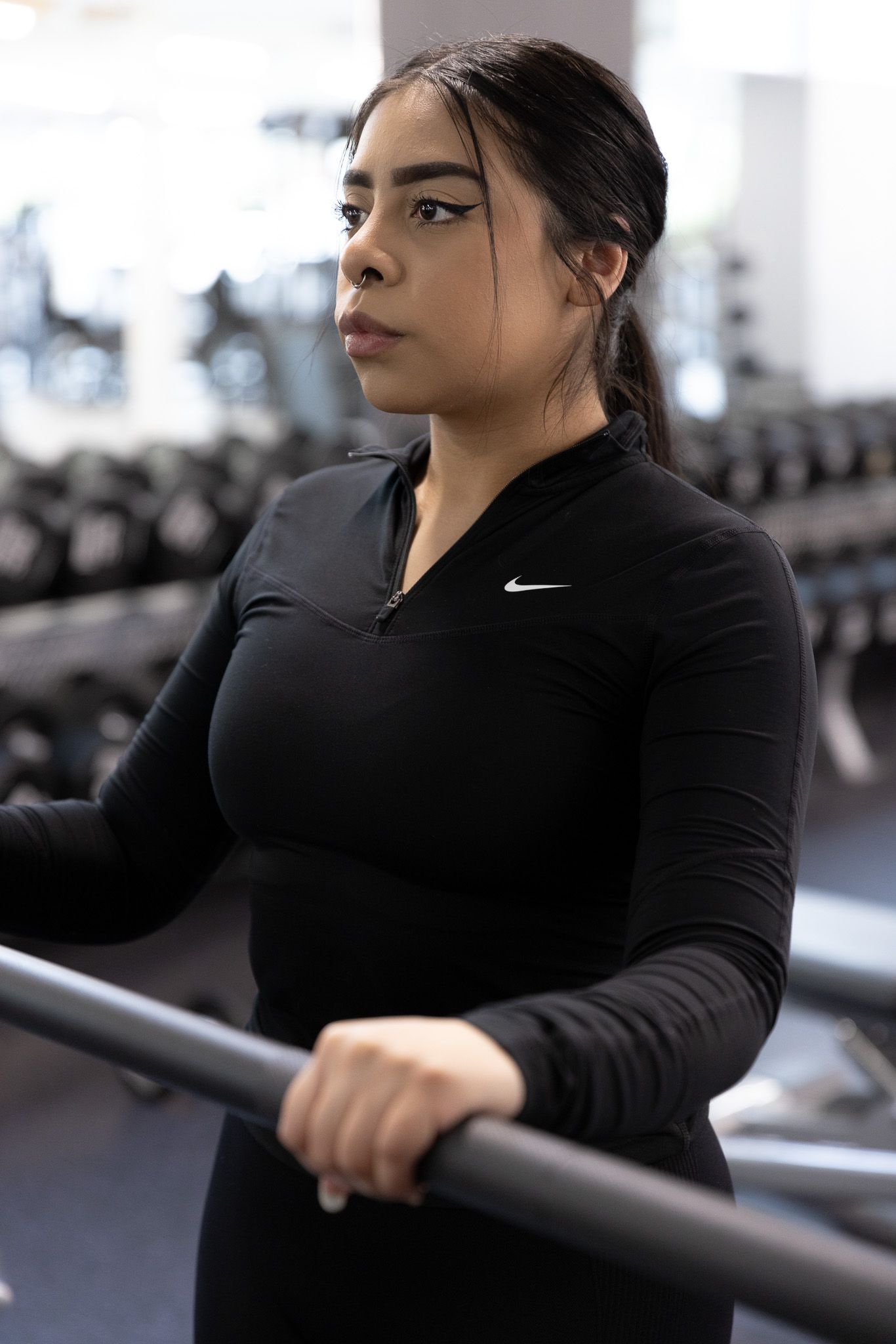 Athletic woman in black Nike workout gear training at the gym.