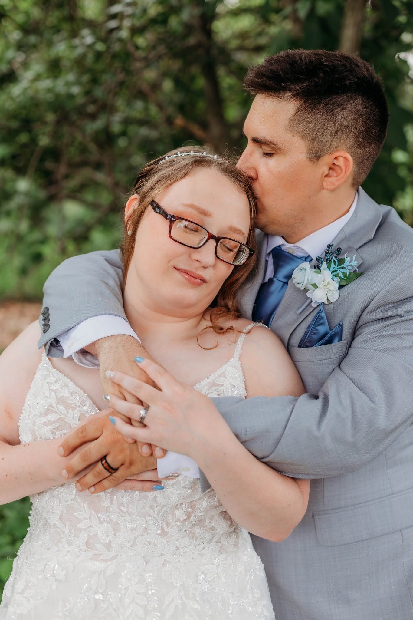 Romantic wedding moment captured in an outdoor garden setting.