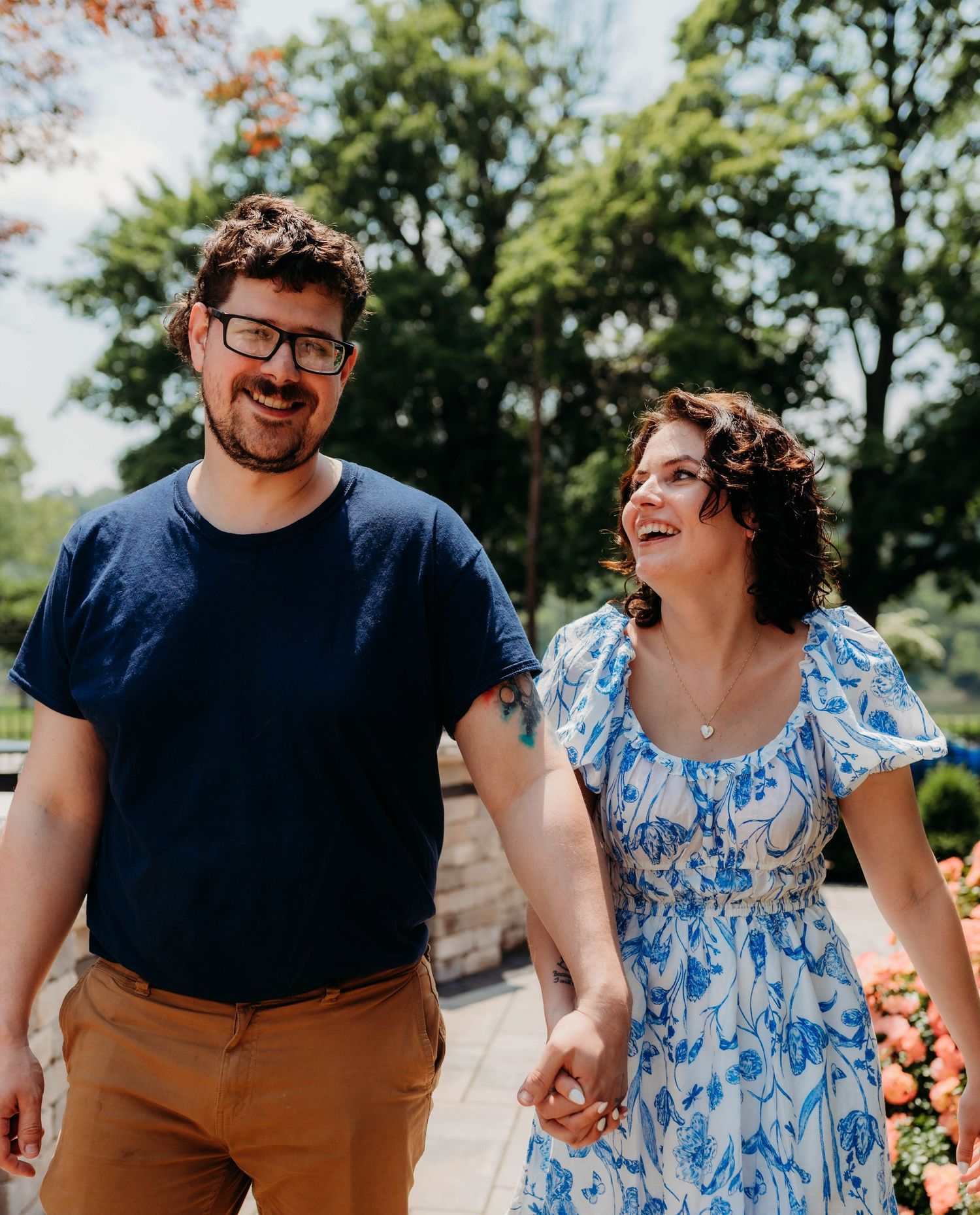 Couple sharing a joyful moment outdoors wearing coordinated blue outfits.