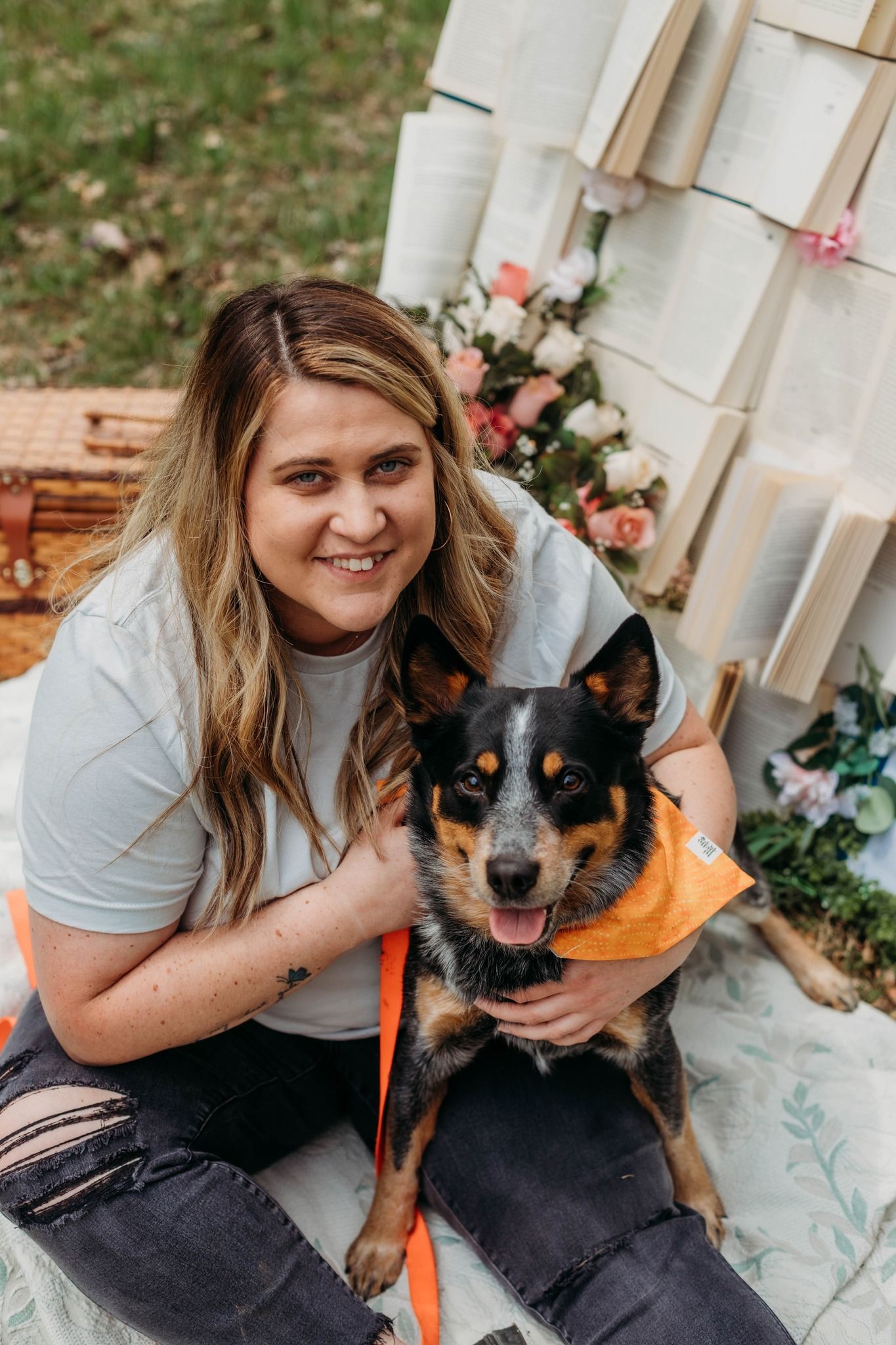 A happy moment captured with a black and orange Australian Cattle Dog wearing an orange bandana.