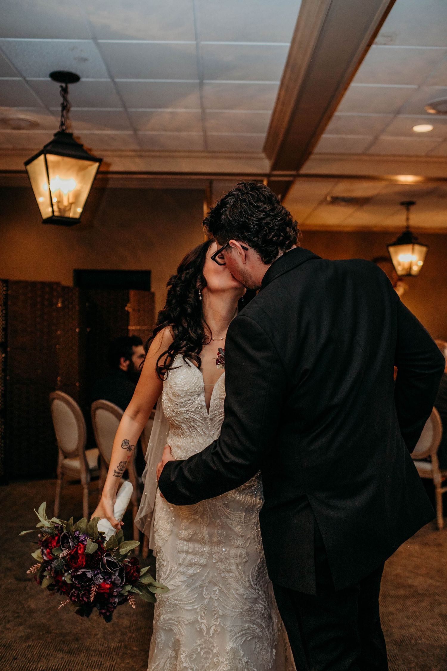 A  newlywed couple shares a  kiss during after their 
