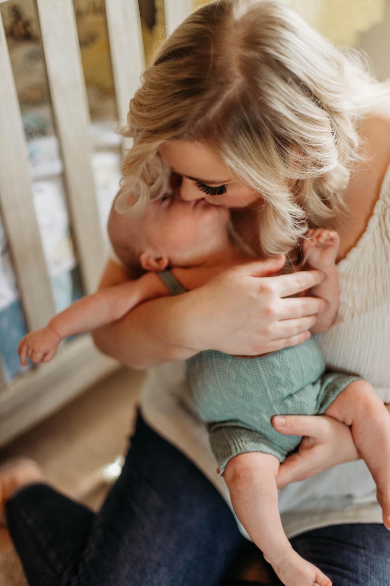 Sweet candid moments captured on a white porch showing affectionate interactions.