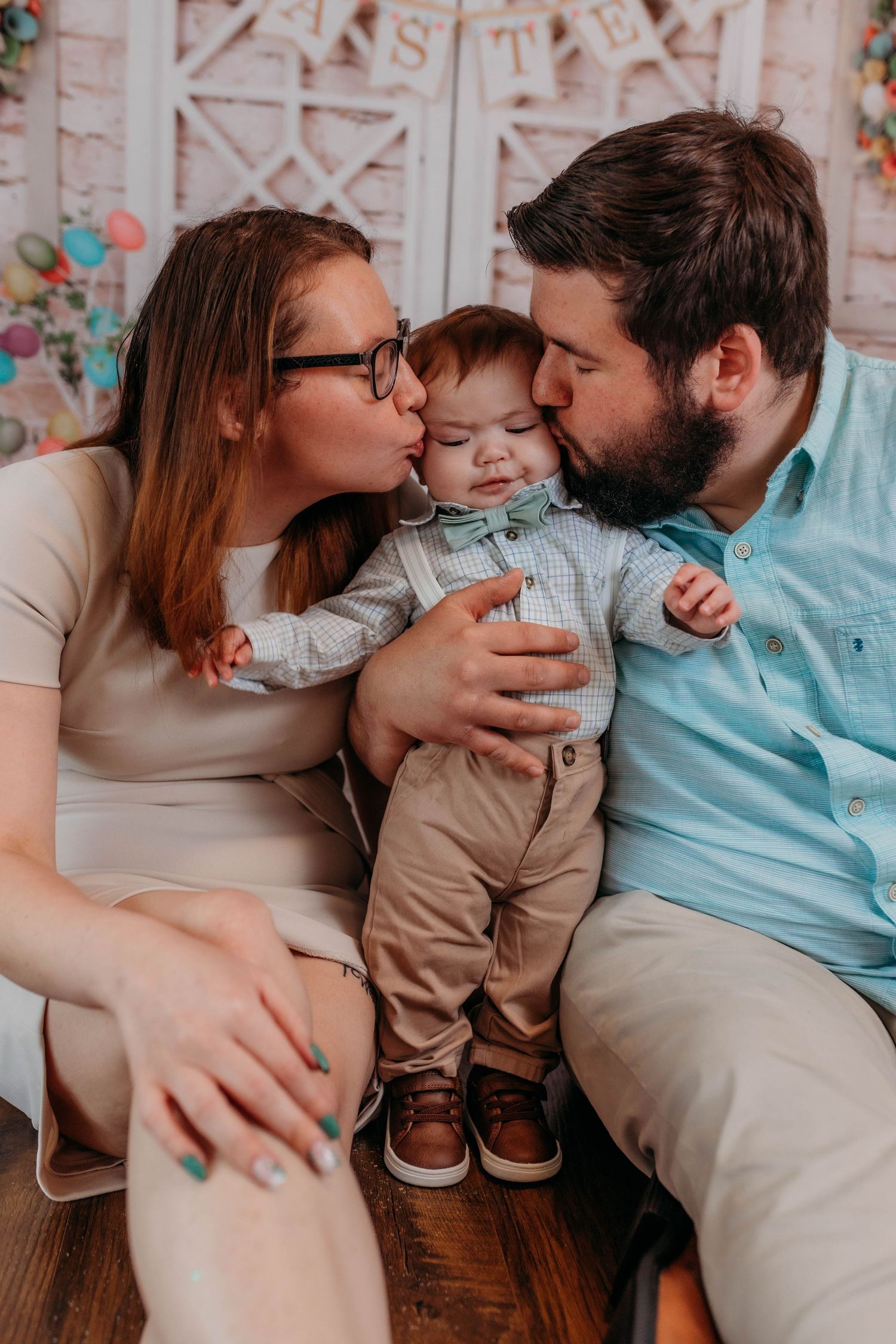 Indoor family portrait with decorative white lattice background and spring decor.
