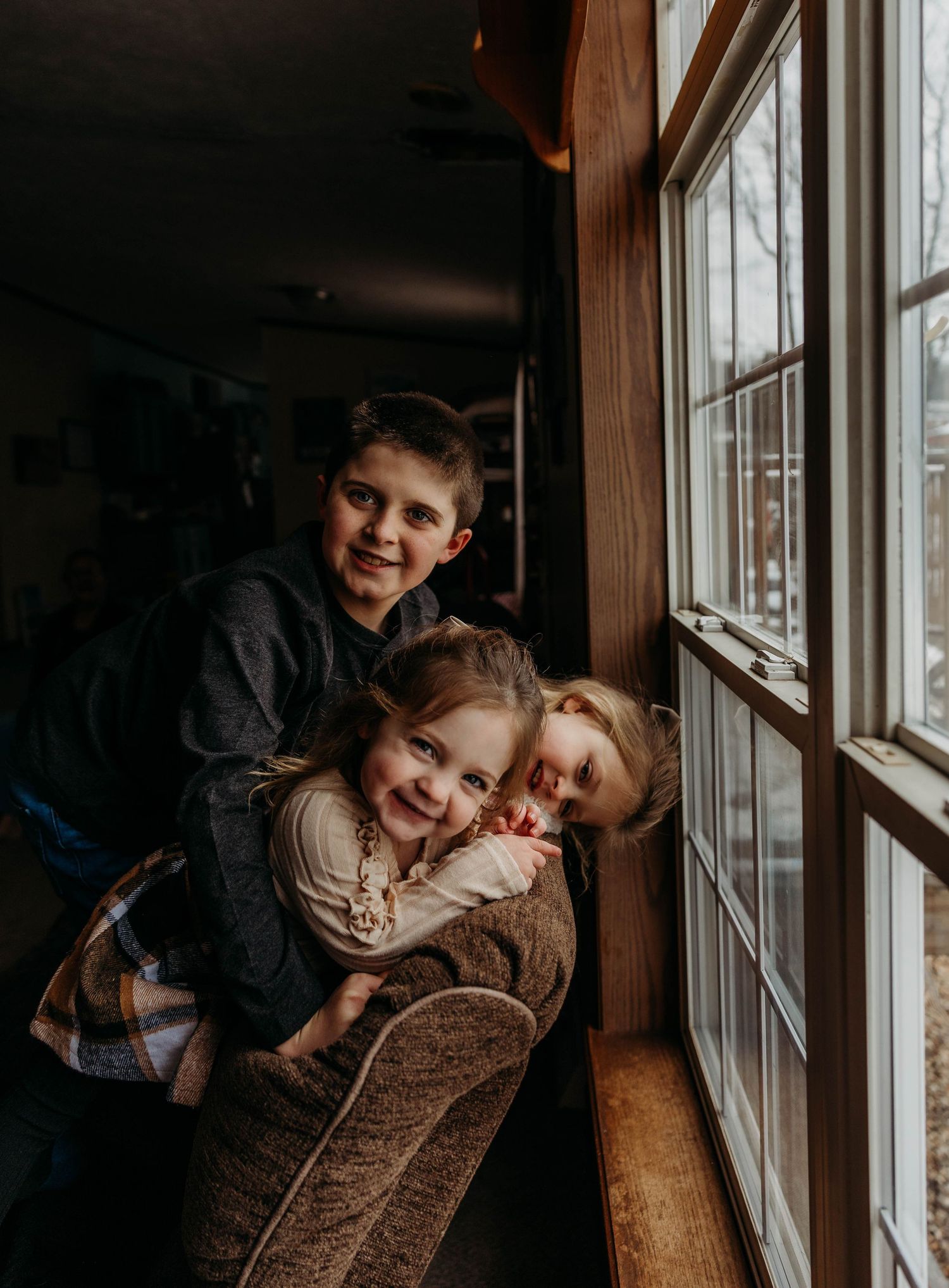 a playful laughter moment between siblings for an in home lifestyle session.