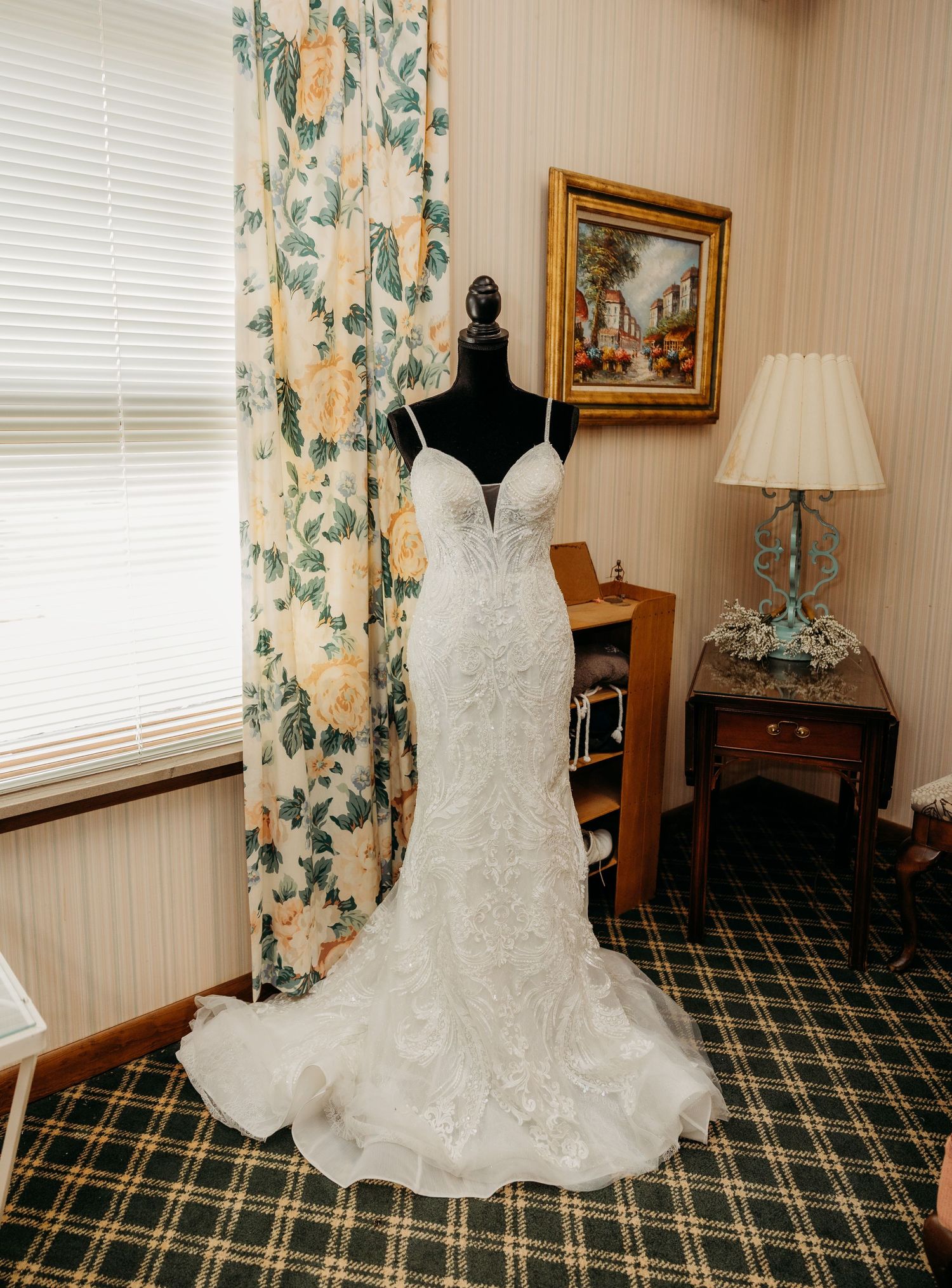 A white lace wedding dress displayed on a mannequin to showcase the beauty of the perfect wedding dress.