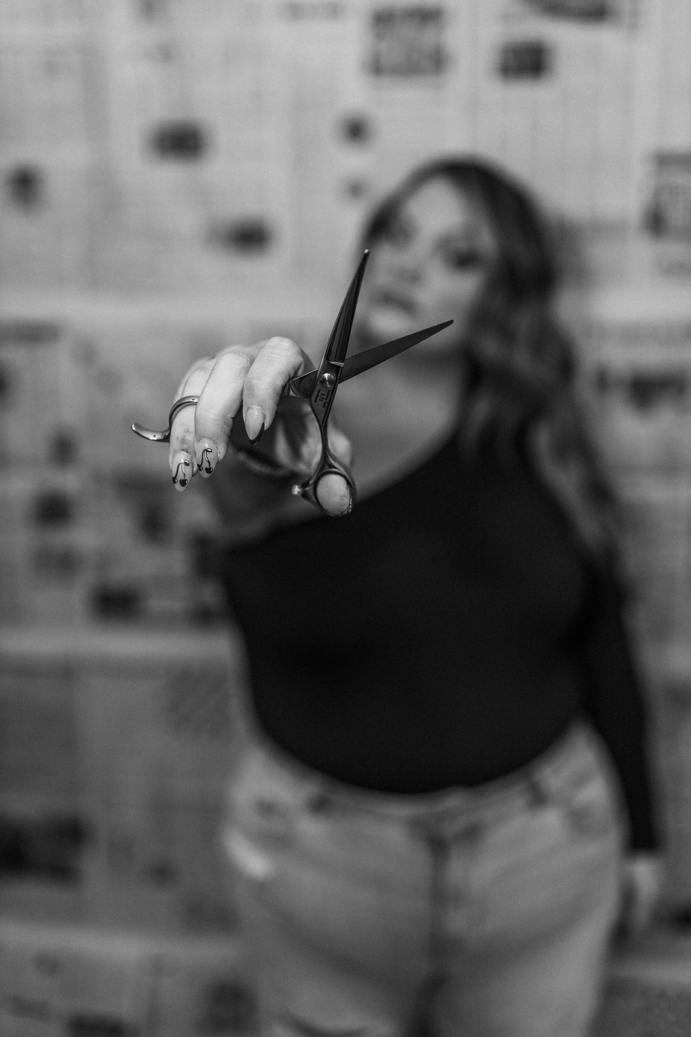 Black and white close-up sequence of hand gestures against blurred background.