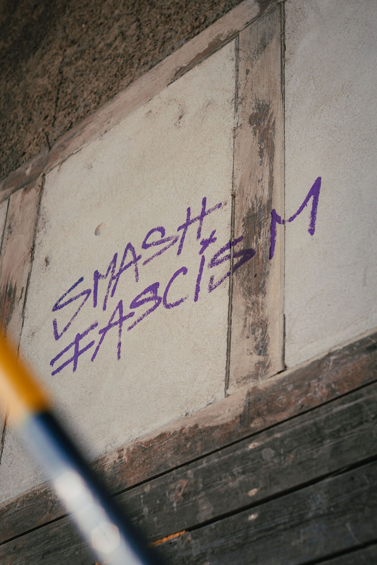 A graffiti artwork on a house wall, featuring bold colors and expressive message.