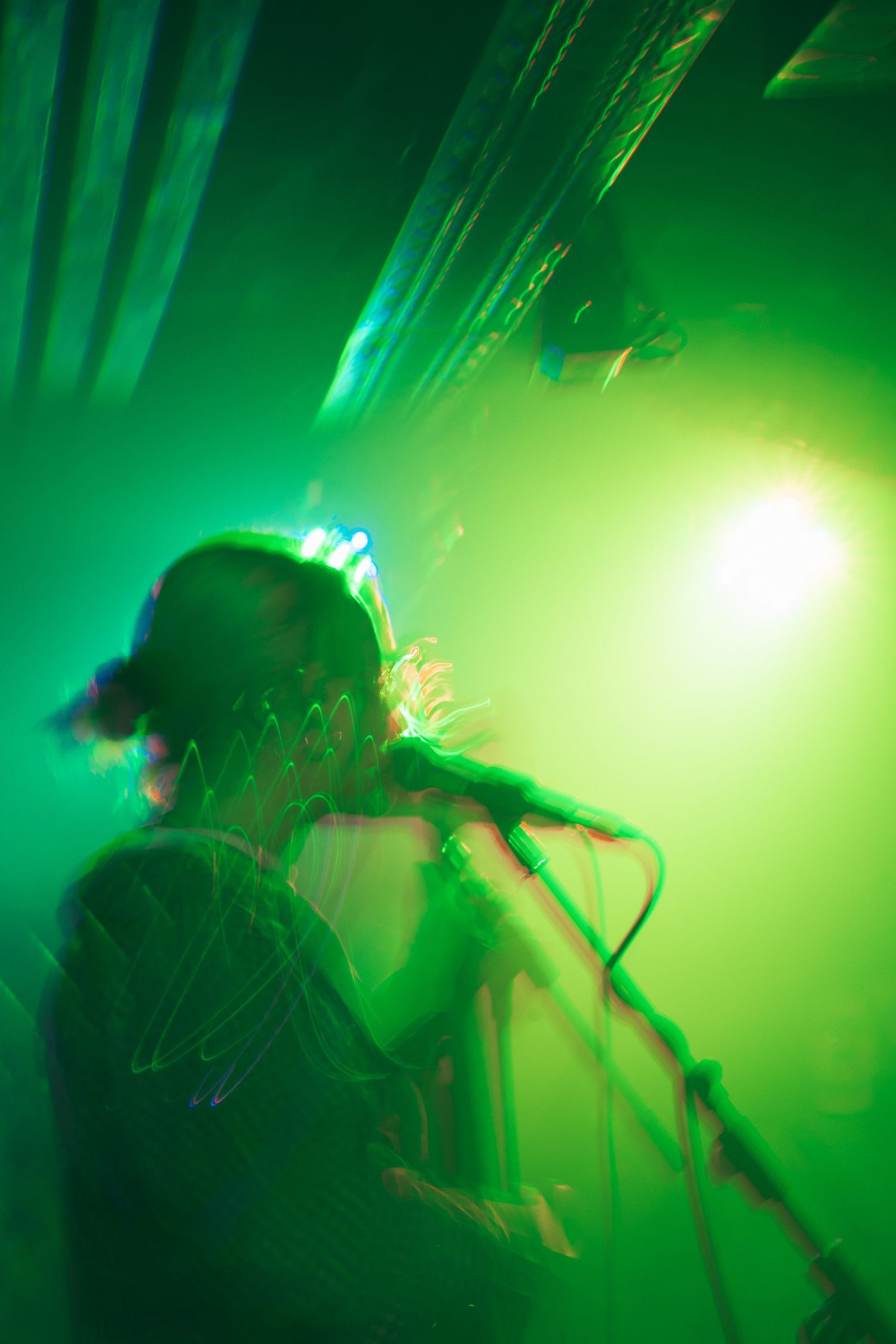 Live performance of Lisl on stage at Kulturzentrum Engelsburg. Vibrant lighting and energetic atmosphere.