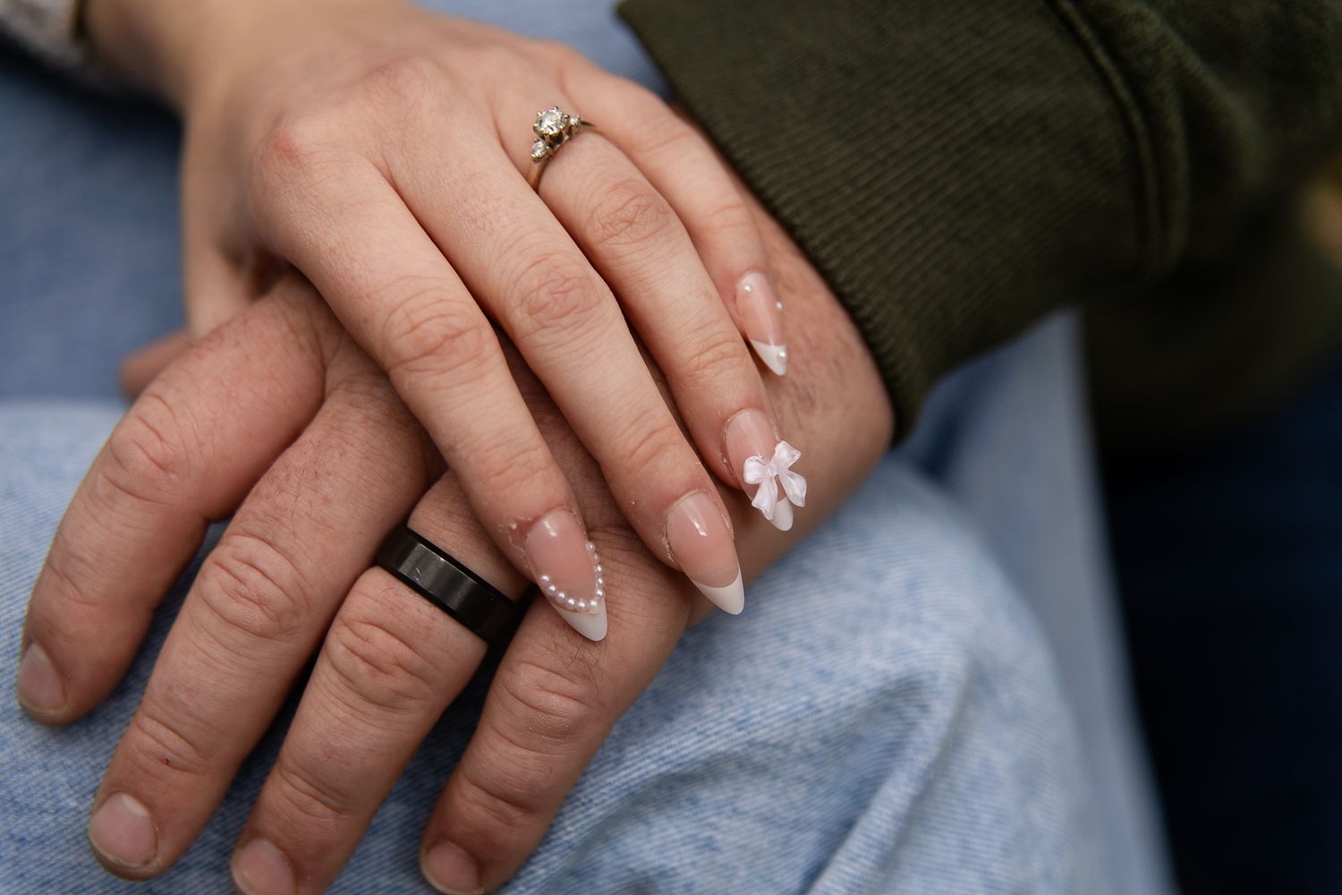 close up shot of a man and womans hands with their wedding rings