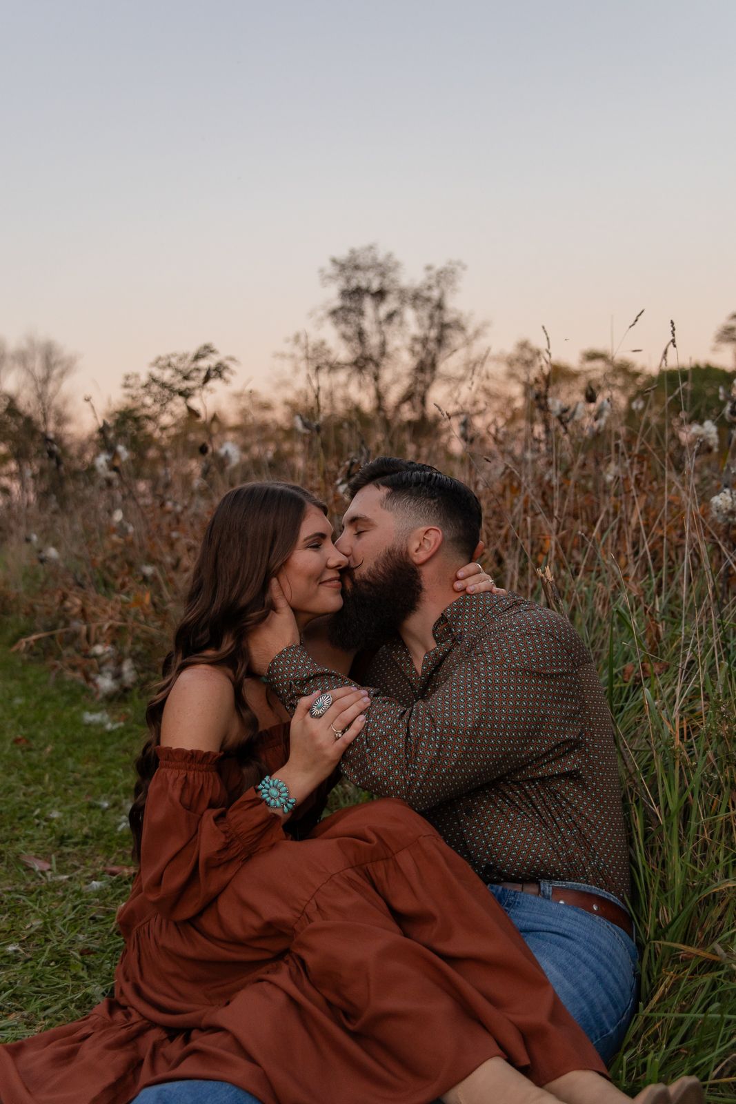 man kissing womans cheek in a field during their western pennsylvania engagement session