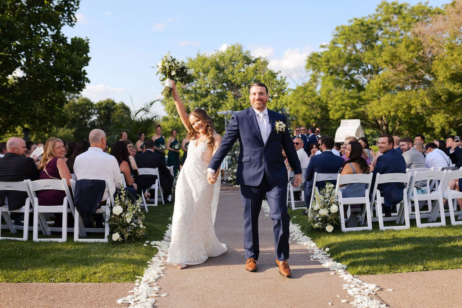 Bride and groom joyfully leaving wedding ceremony at Phipps in Pittsburgh, PA