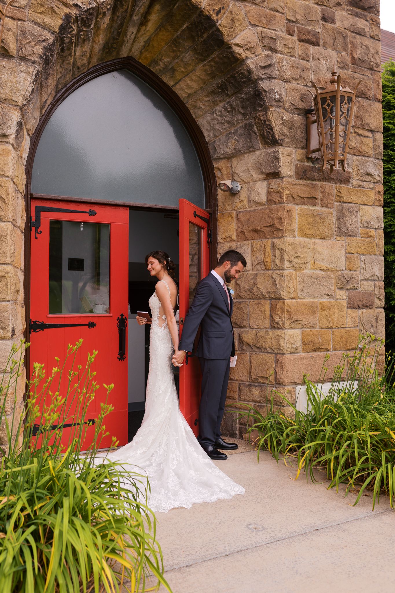 bride and groom having a private moment while holding hands during their first touch