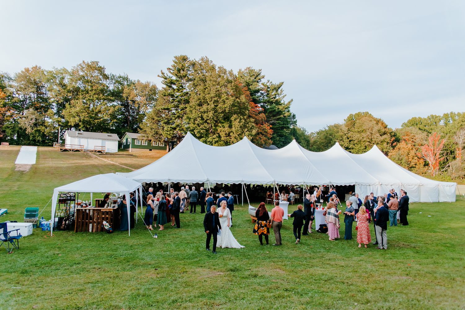 backyard wedding with guests and bride & groom mingling during cocktail hour