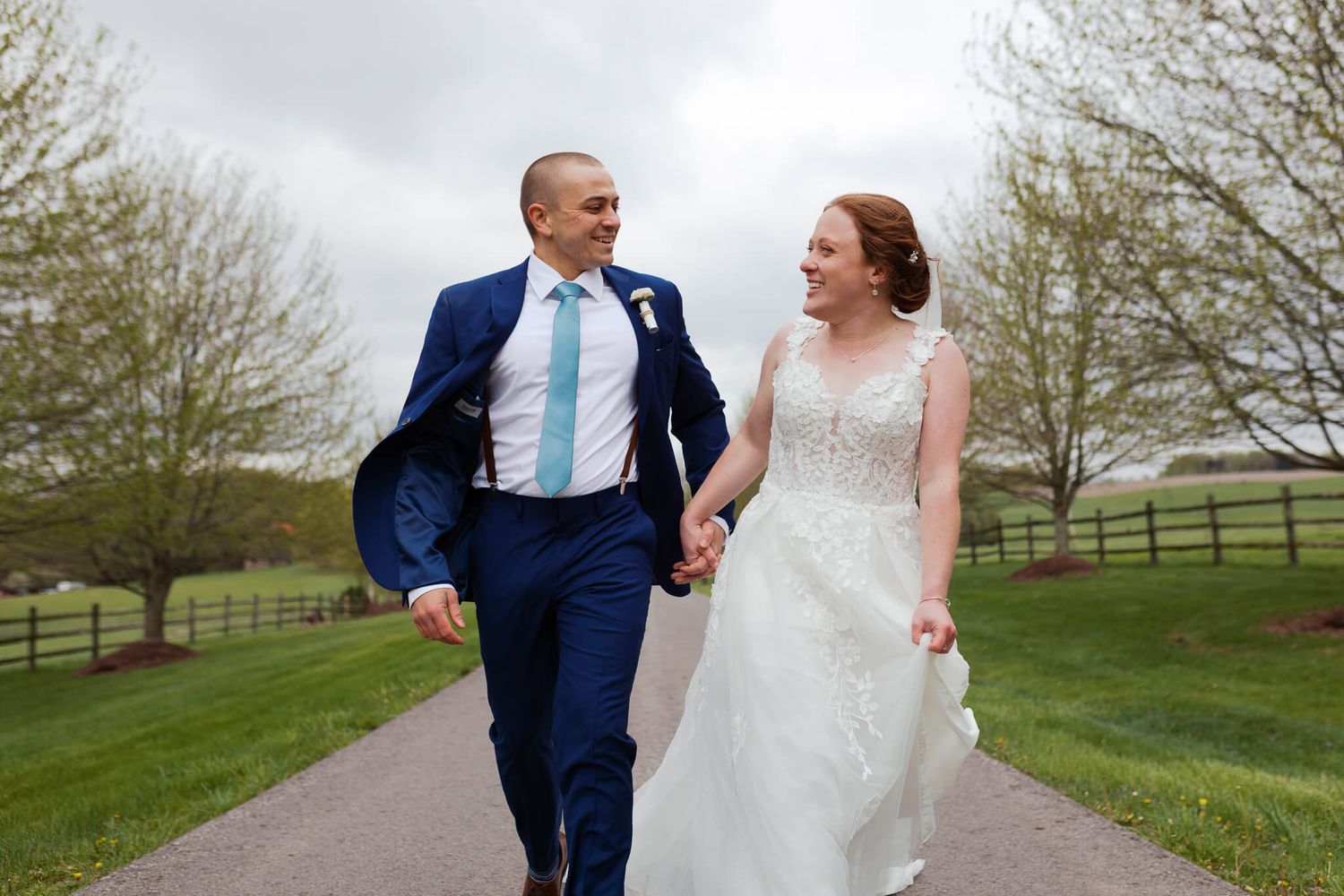 bride and groom running joyfully together while holding hands