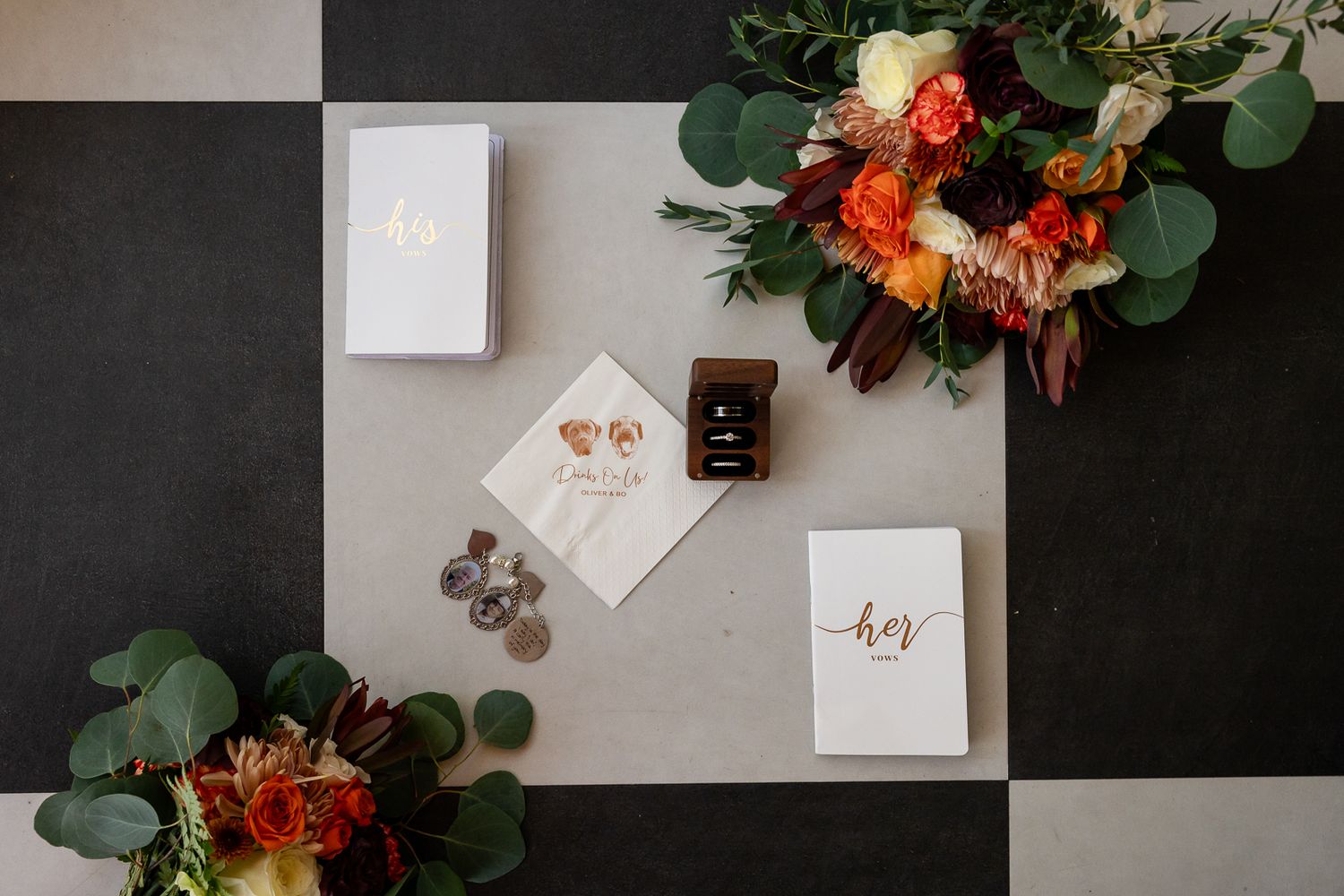aerial view of a wedding flatlay featuring personalized invitations, wedding bouquet, jewelry and shoes