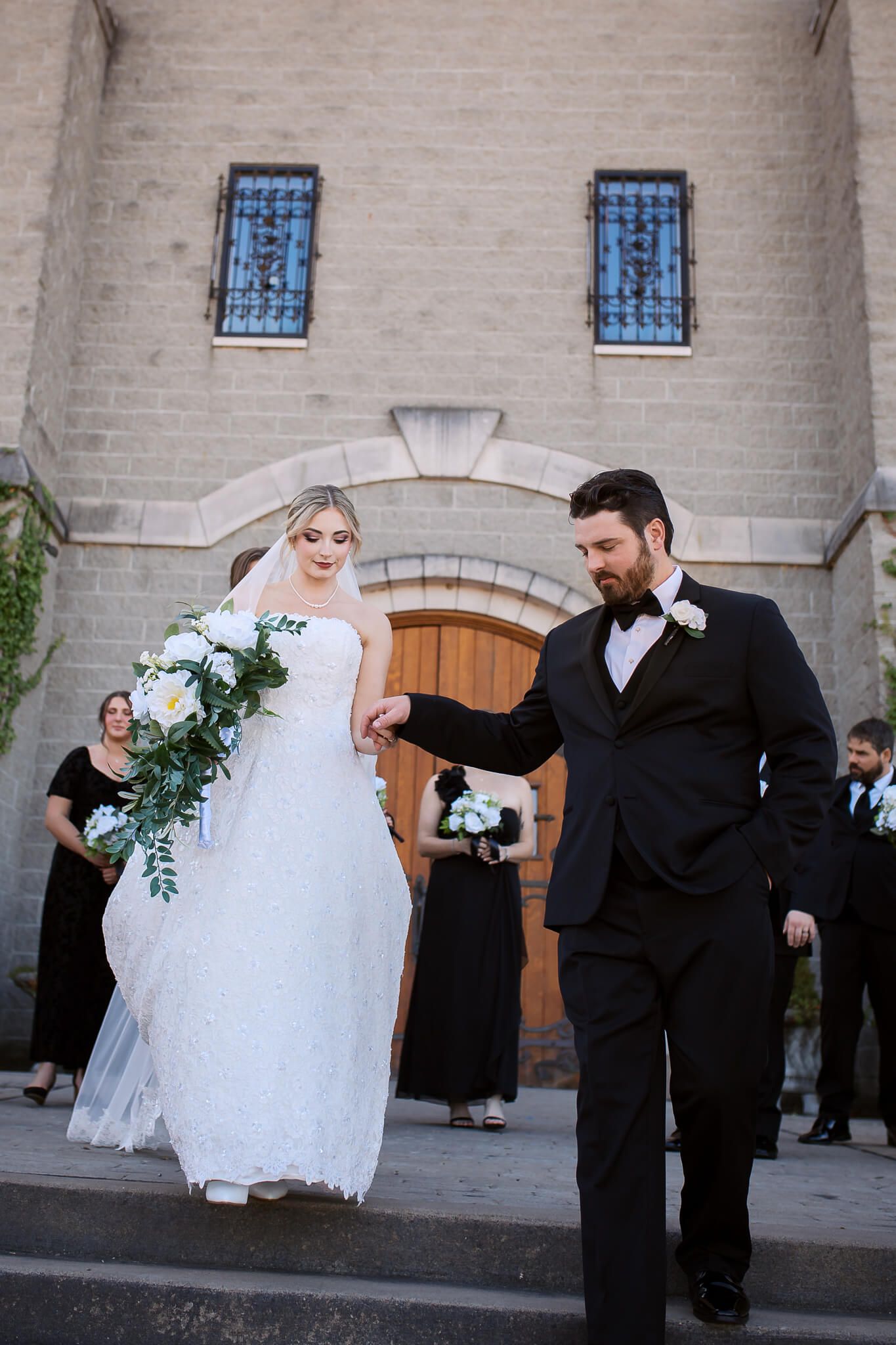 Bride and groom holding hands and walking toward photographer, Emma Craven, during bridal portraits at Pittsburgh wedding venue.