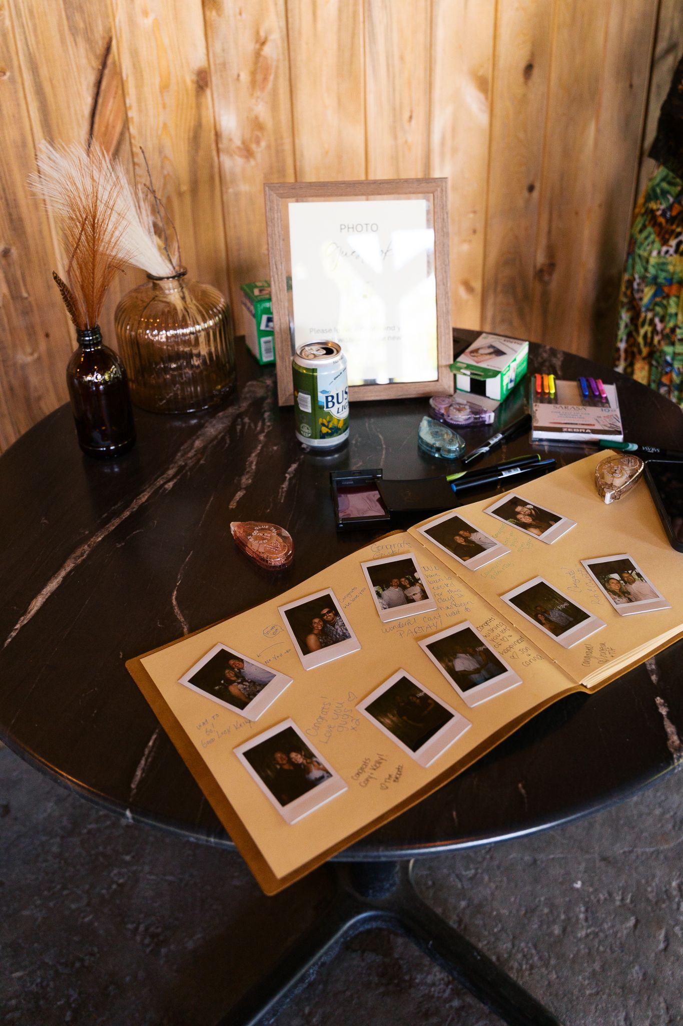 polaroid wedding guestbook set up in a well-lit area during the reception