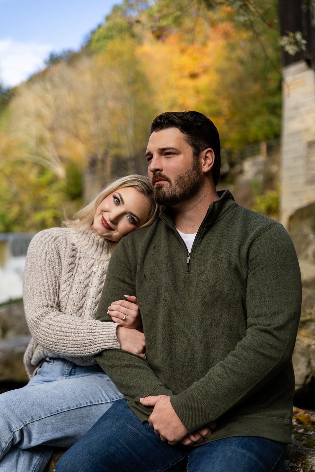 blonder woman in white sweater holds on to man in green sweater at McConnels Mill