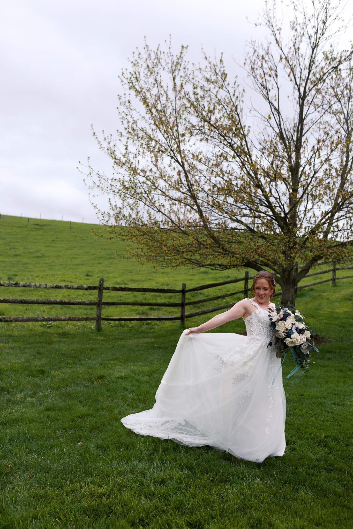 woman holding her wedding gown with one hand and her bouquet in the other