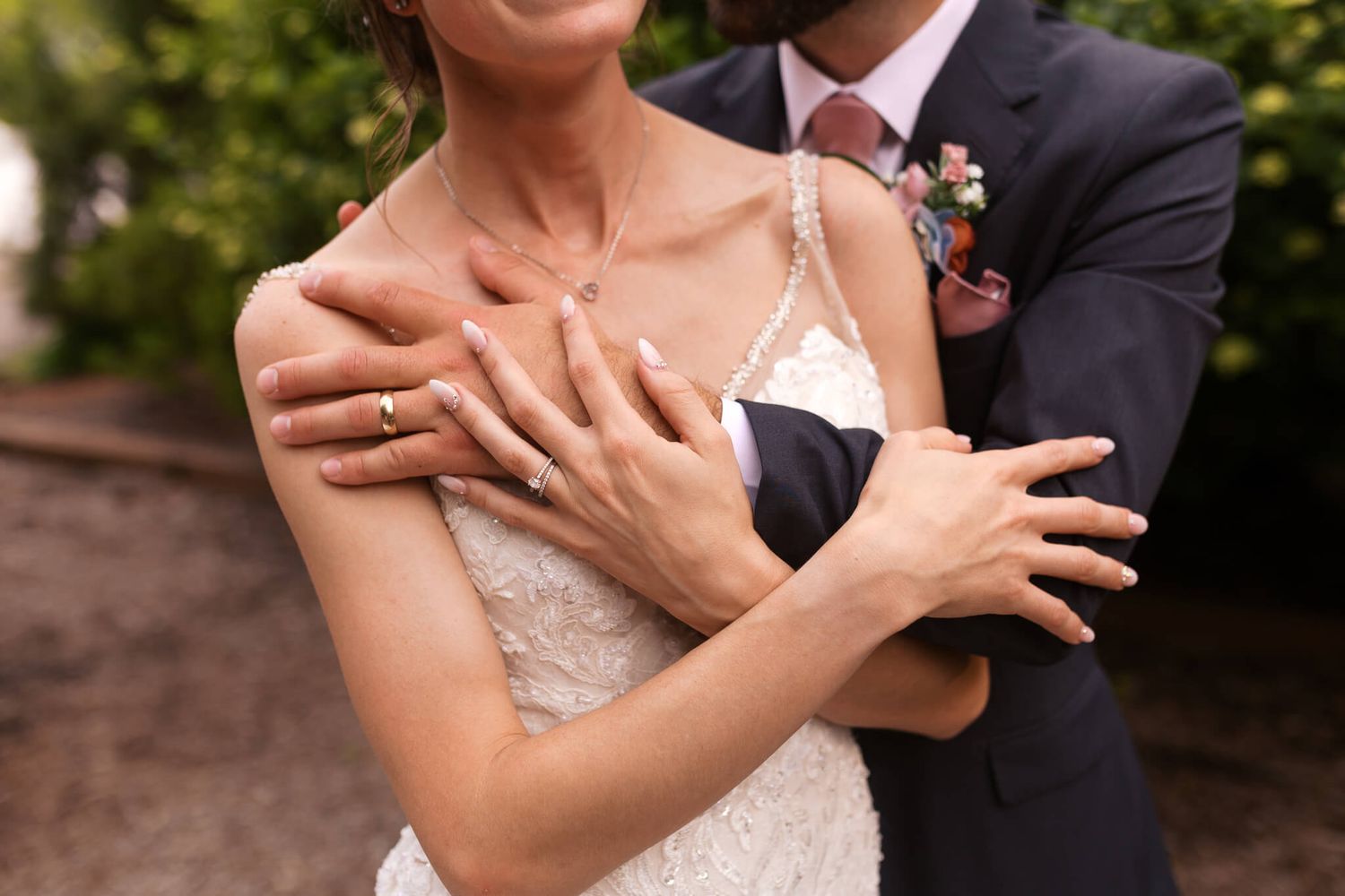 close up shot of man and womans hands with wedding rings