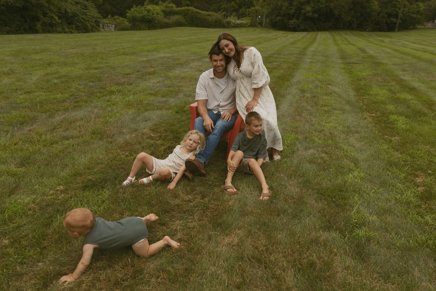 Family Photos near Milford Pennsylvania in a field at sunset with a Adirondack chair.