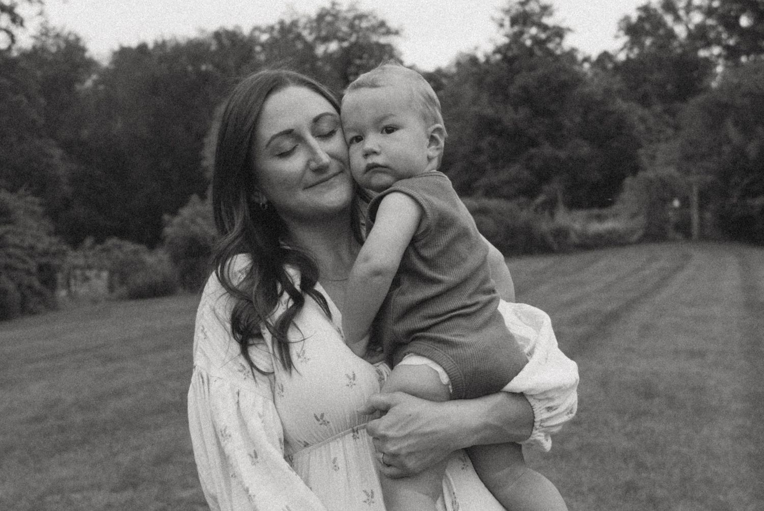 Motherhood photos of a mom holding her child, with her face against his. Emotive motherhood photo taken in Milford, Pennsylvania.