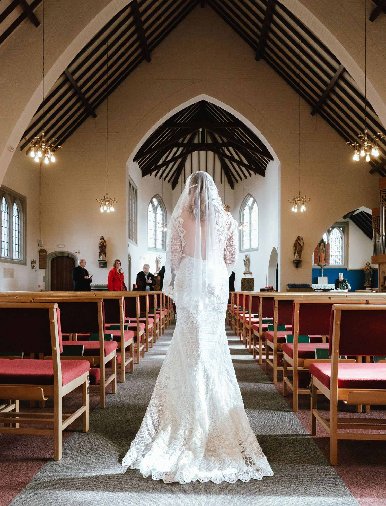 full wedding dress shot with a view of the church on the brides wedding day