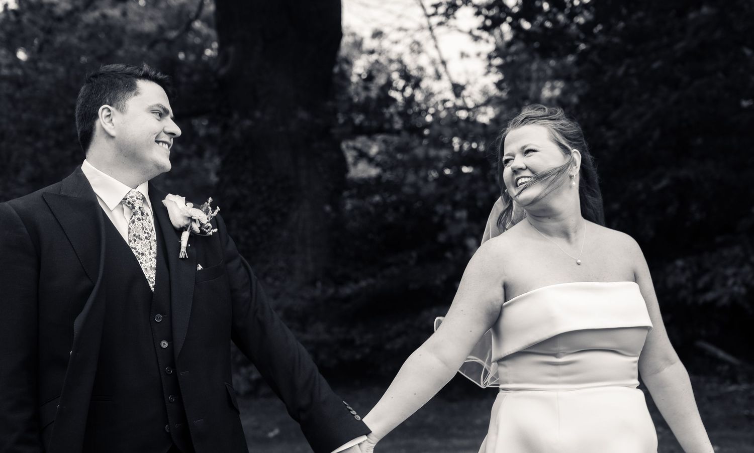 black and white photo of couple just married looking into each others eyes.