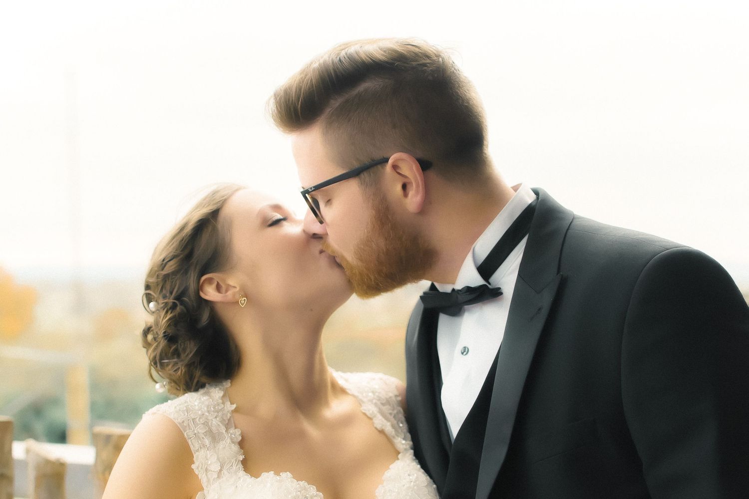 married couple kissing under soft lighting