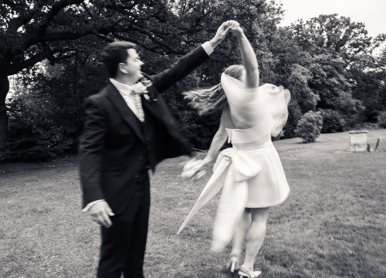 Blurry photo of newly weds dancing in black and white