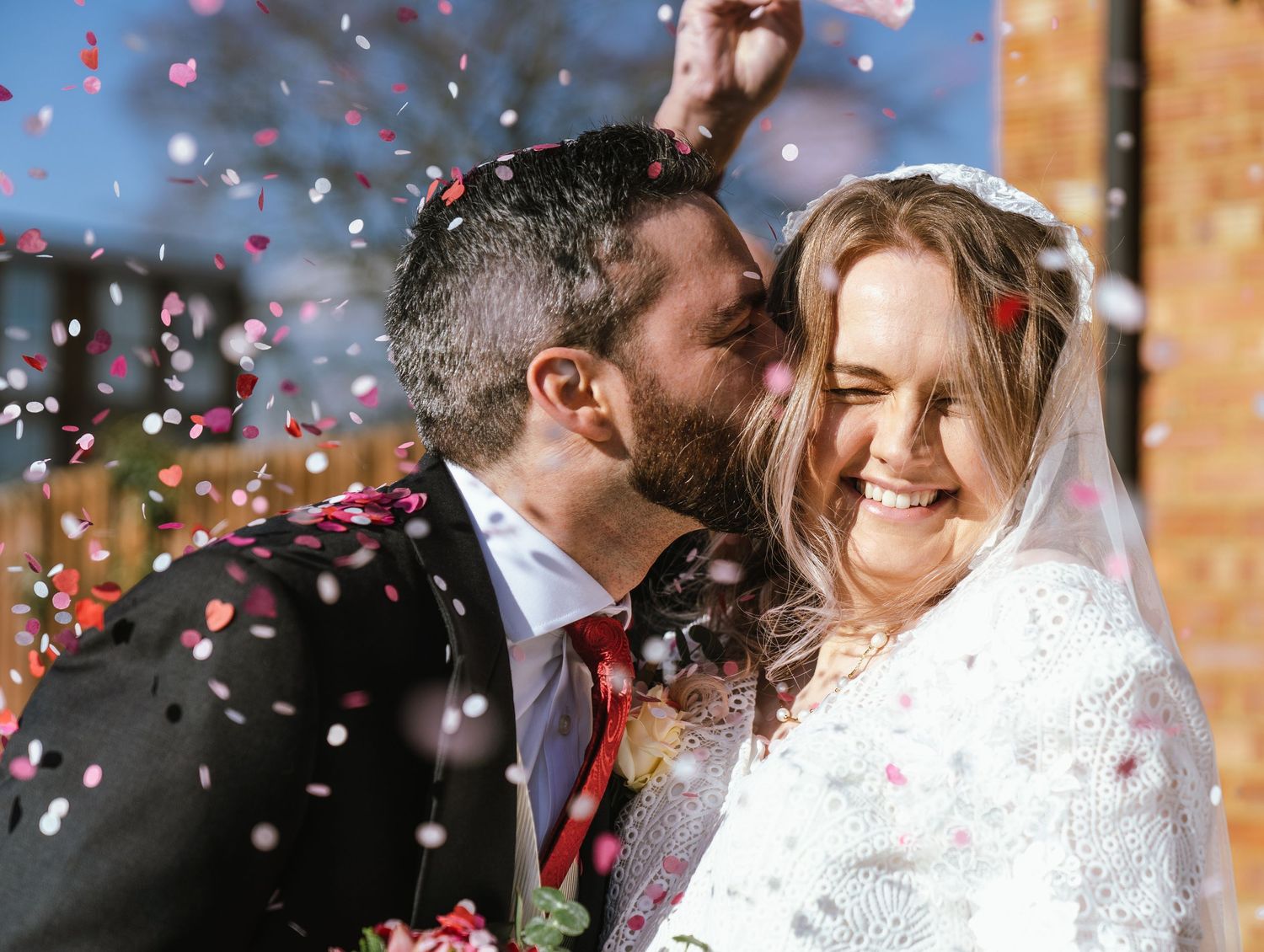 newly wed couple joyous after getting married under confetti