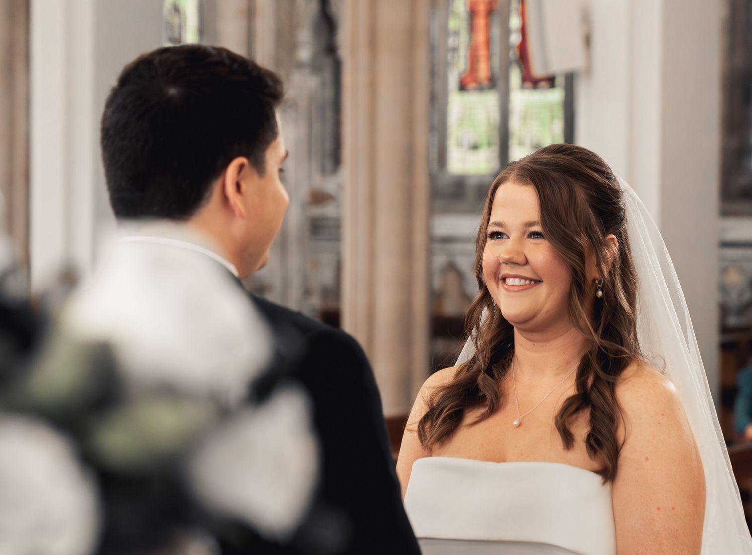 wedding photographer captures bride and groom from a discrete angle whilst getting married