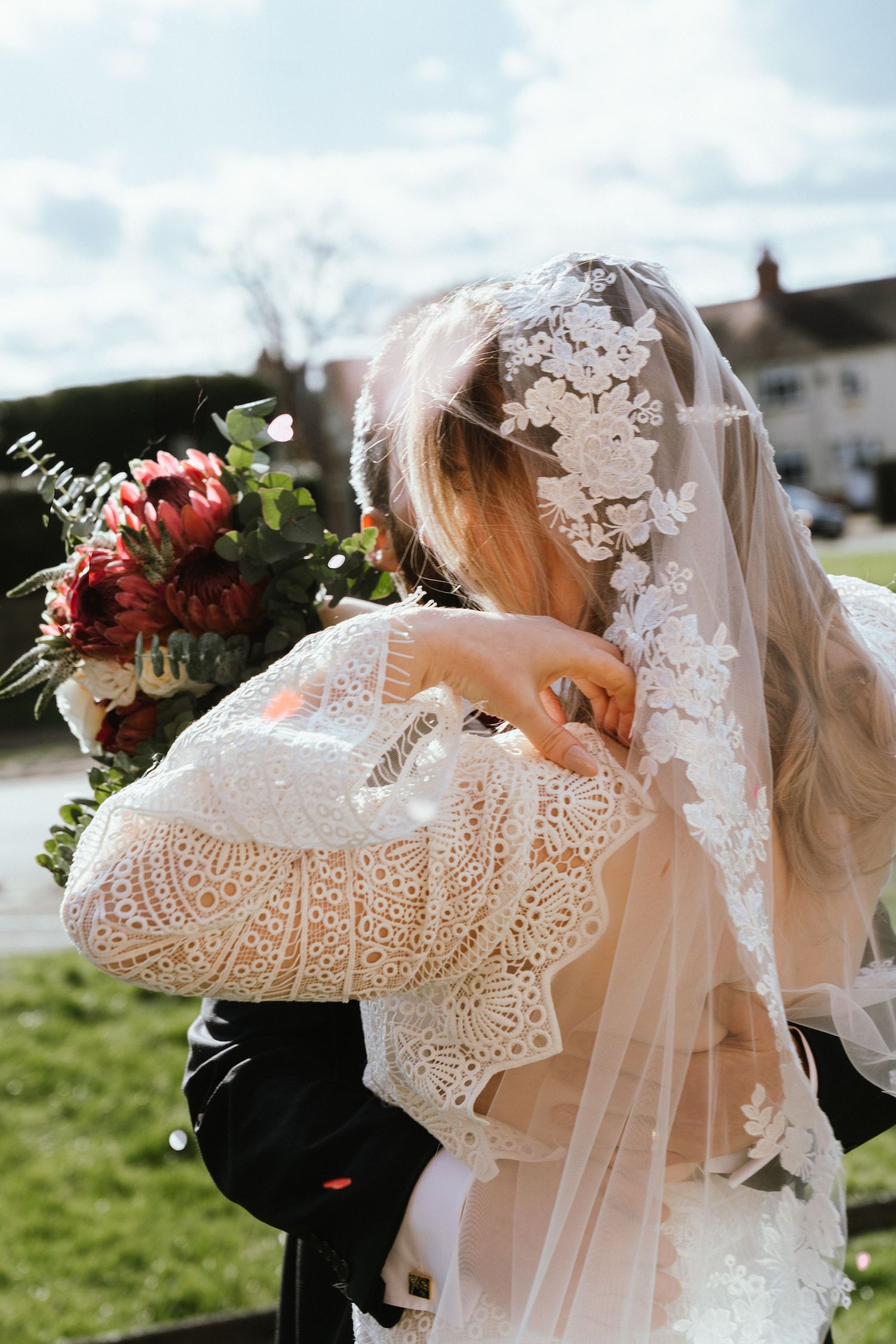 photo of a brides beautiful veil on the sunny day of her wedding.