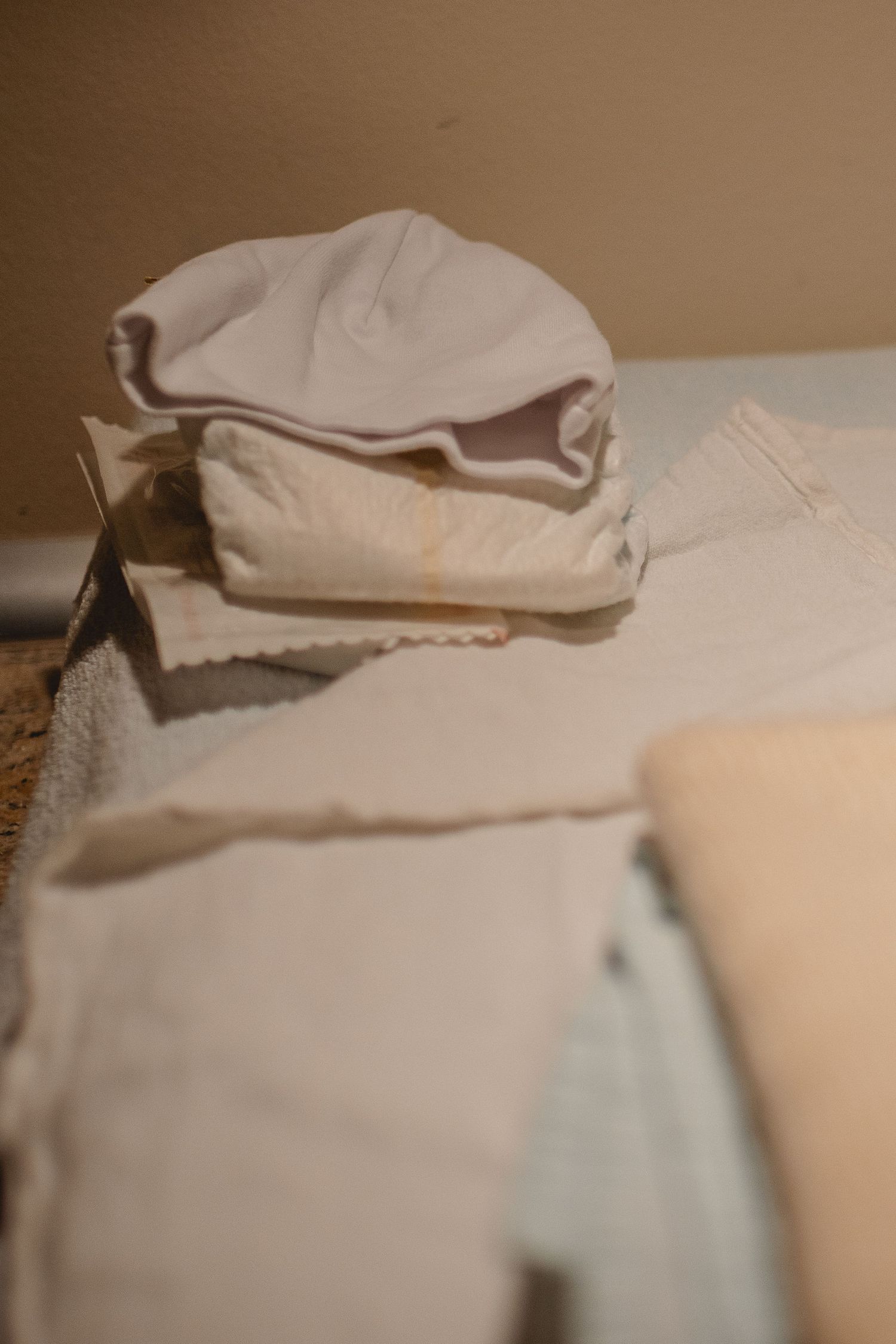 Newborn clothes are laid out, ready for after the birth in Orange County.