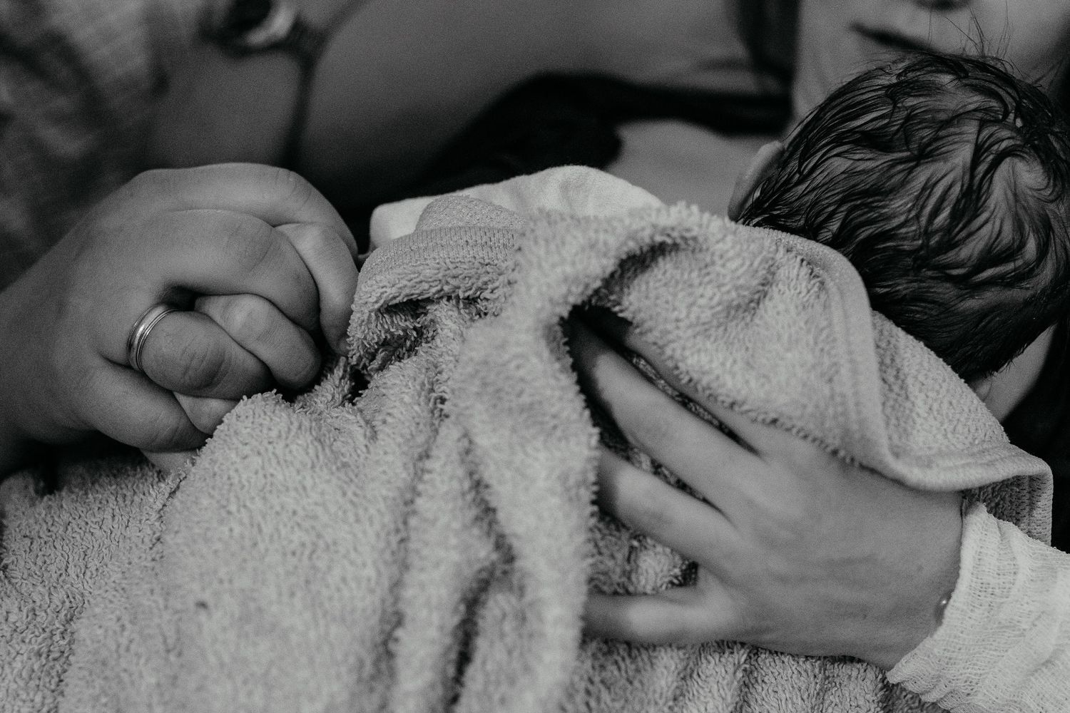 A few minutes old newborn lies sleeping on the mother’s chest in Orange County.