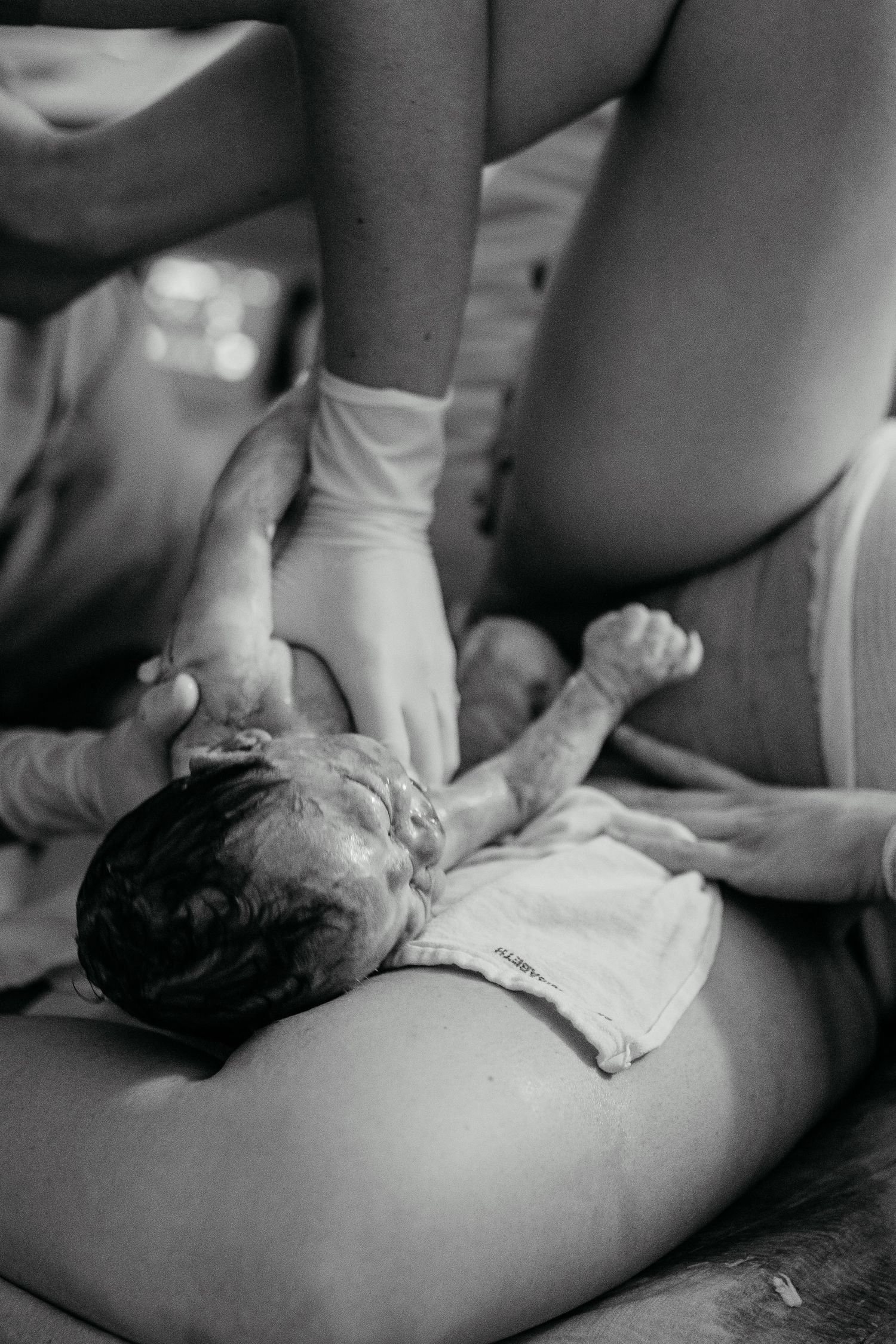 Black-and-white image of a baby’s birth in Laguna Beach.