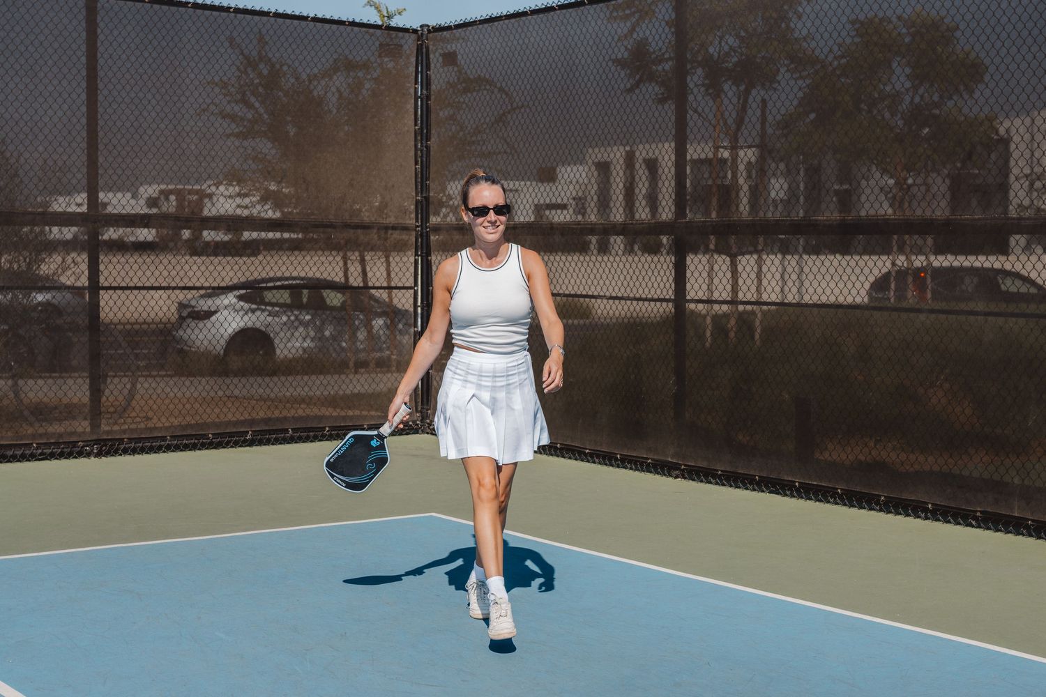 A sequence of tennis action shots showing serves and returns on an outdoor court during daytime play in Newport Beach.