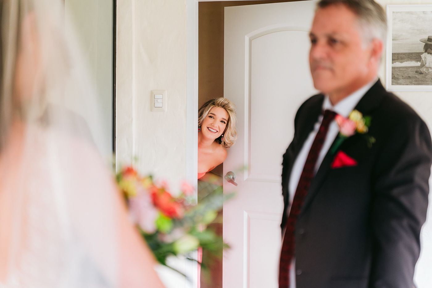 Elegant wedding party members in formal attire pose in a row at a celebration.