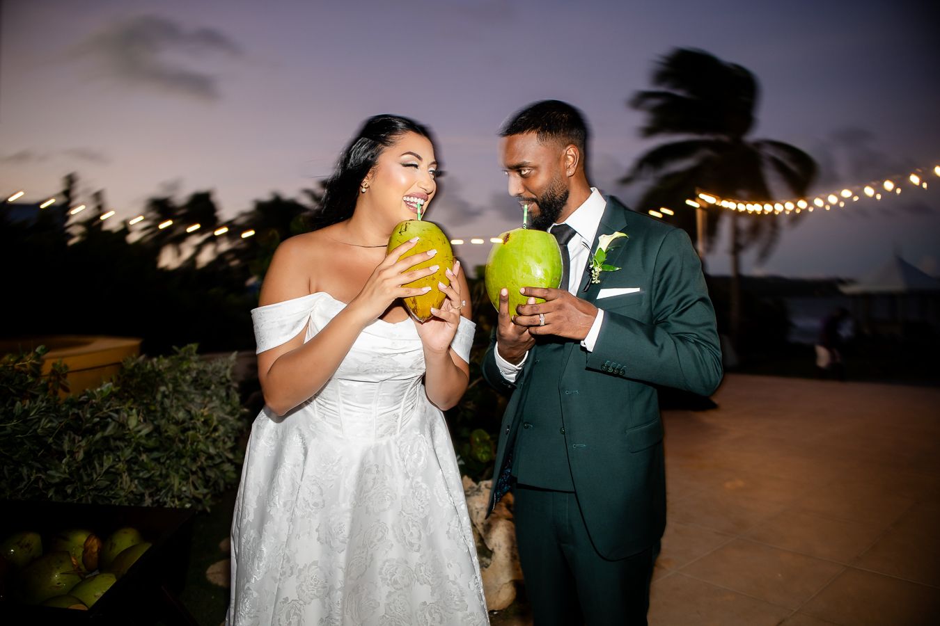 Evening wedding celebration with string lights and tropical ambiance.