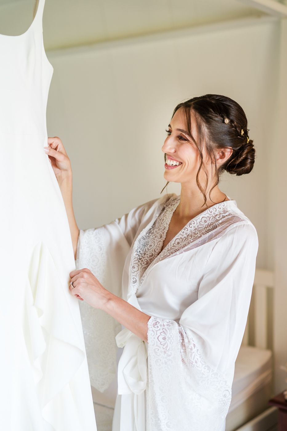 Person in white lace robe getting ready in bright room.